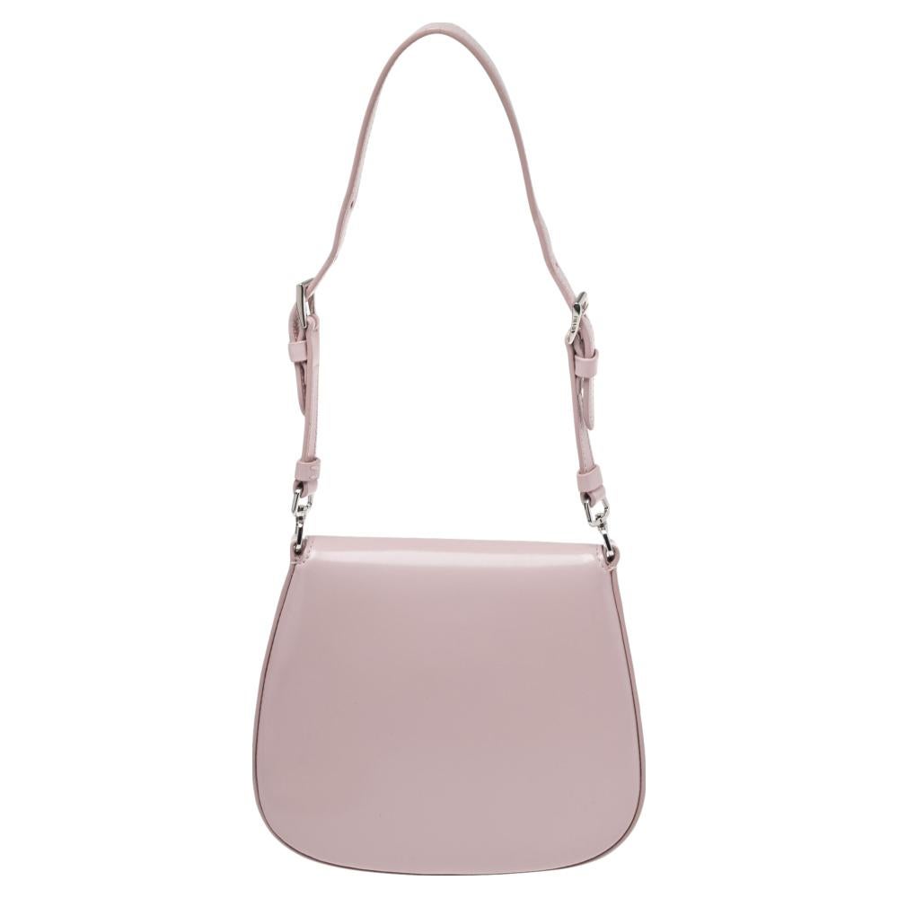 Prada’s Cleo bag is made in Italy from leather into a silhouette that is refined and has clean curves. The minimalist design is accented with a logo plaque and coordinates with the polished silver-tone hardware.

Includes: Original Box, Authenticity