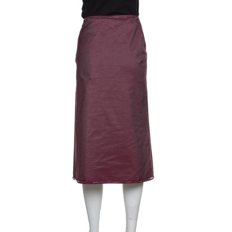 A worthy closet investment, this midi skirt from Prada is an excellent option for evening outings. It is cut from pink-coloured cotton and is adorned with embellished trims on the waistline and hem. Pair this classic with an off-shoulder top and