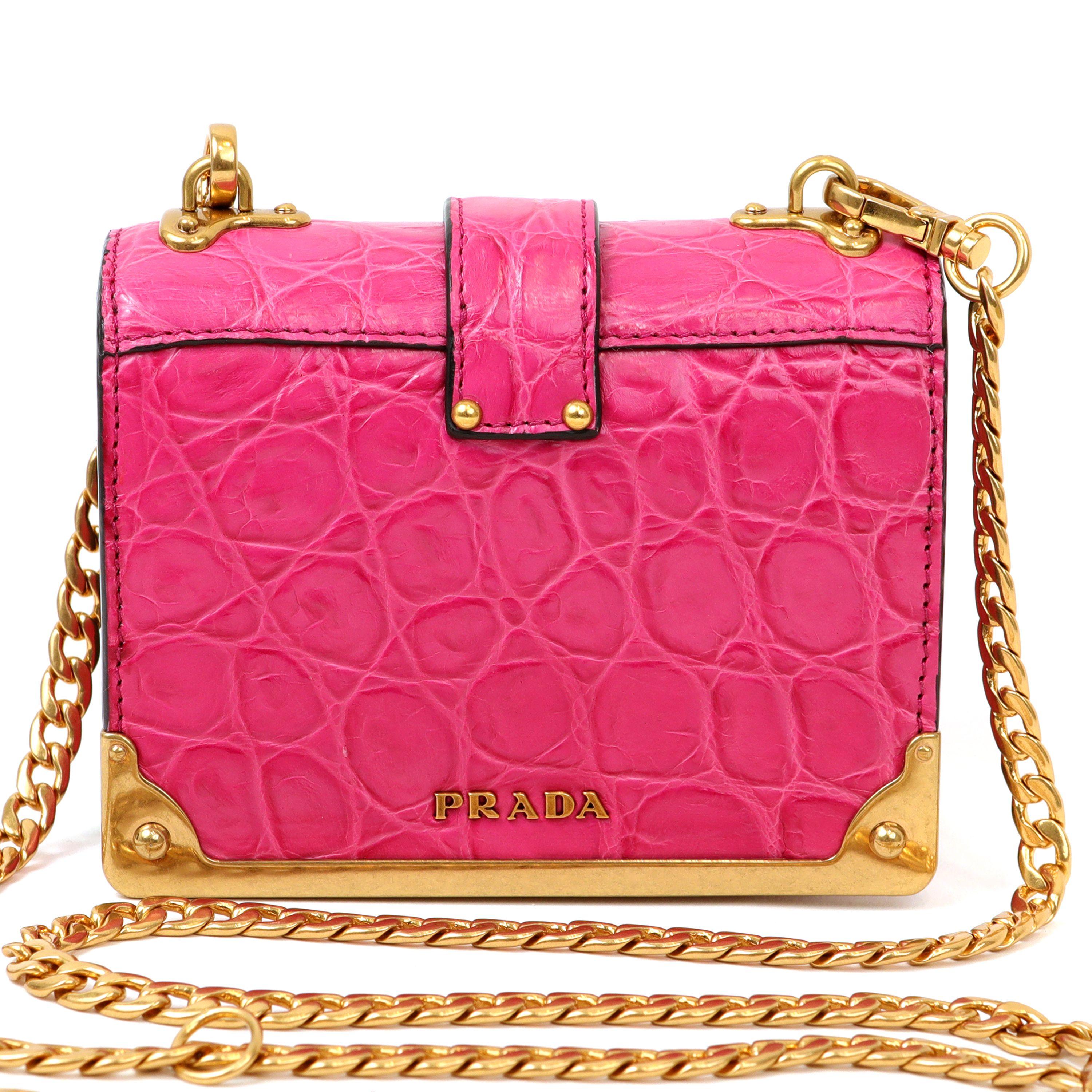 This authentic Prada Pink Crocodile Micro Cahier Bag is in pristine condition.  Bright pink crocodile with gold hardware.  Long gold tone chain strap. Dust bag included.

PBF 13769
