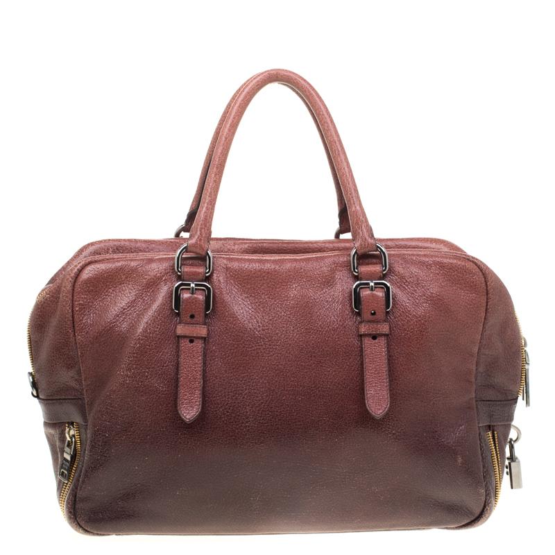 When you carry this Prada creation, be ready to catch admiring glances as this bag is stylish and handy. The bag has been crafted from leather in shades of pink/eggplant and equipped with two top handles and a very spacious nylon