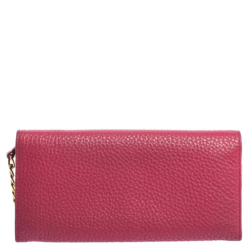 Prada brings you yet another gorgeous accessory with this wallet. It has been crafted from pink grained leather and has a flap that reveals a well-sized leather and nylon-lined interior with multiple card slots and a zip pocket. The lovely creation