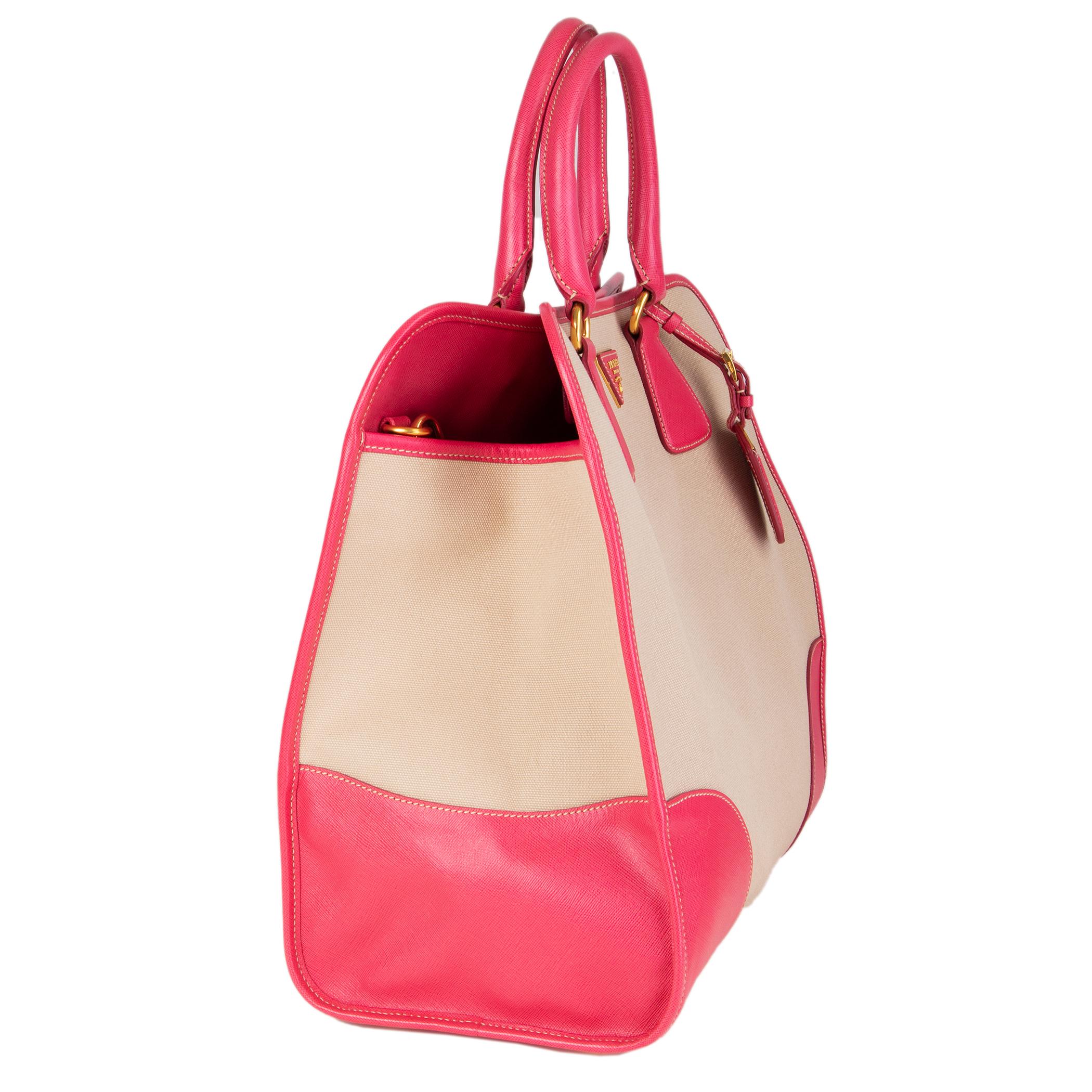 Prada framed 'North-To-South Tote Bag' in beige hemp canvas and pink Saffiano calf leather details. Opens with a snap button on top. Lined in pink classic Prada nylon lining with one zipper pocket against the back and front with two attached open