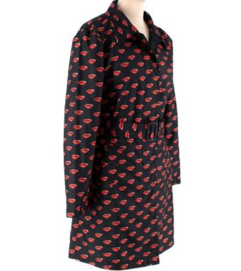Prada Black Lip Print Nylon Belted Short Trench Coat

- Black gabardine with a signature repeating lip print
- Point collar, waist belt, concealed button fastening, and inset hip pockets
- Storm cape back
- Unlined
- Short, mid-thigh