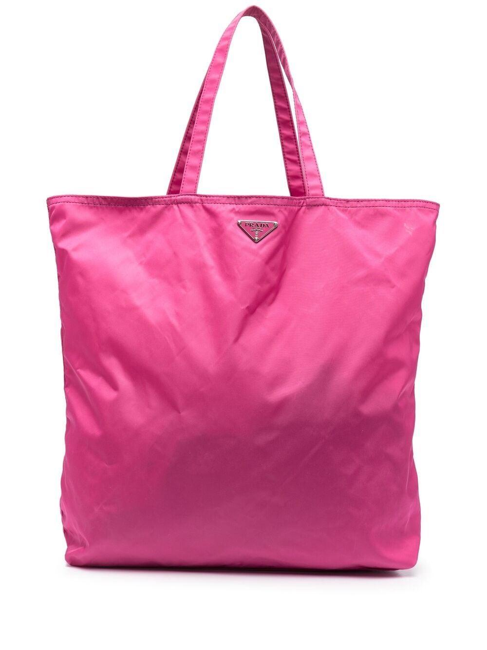 Prada pink Robot nylon tote bag featuring top handles, a front logo plaque, an inside zip pocket, a fancy decorative motive.
100% Nylon
In excellent vintage condition. Made in Italy. 
12.9in. (33cm) X 13.7in. (35cm)
We guarantee you will receive