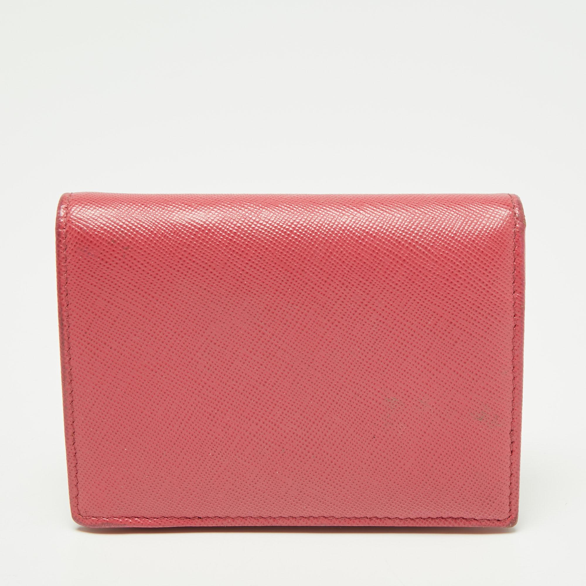 This card case from Prada will help you store your valuables securely. It is made from pink Saffiano leather and flaunts a logo lettering on the front. This bi-fold card case has gold-tone hardware and opens to a leather-nylon interior.

Includes:
