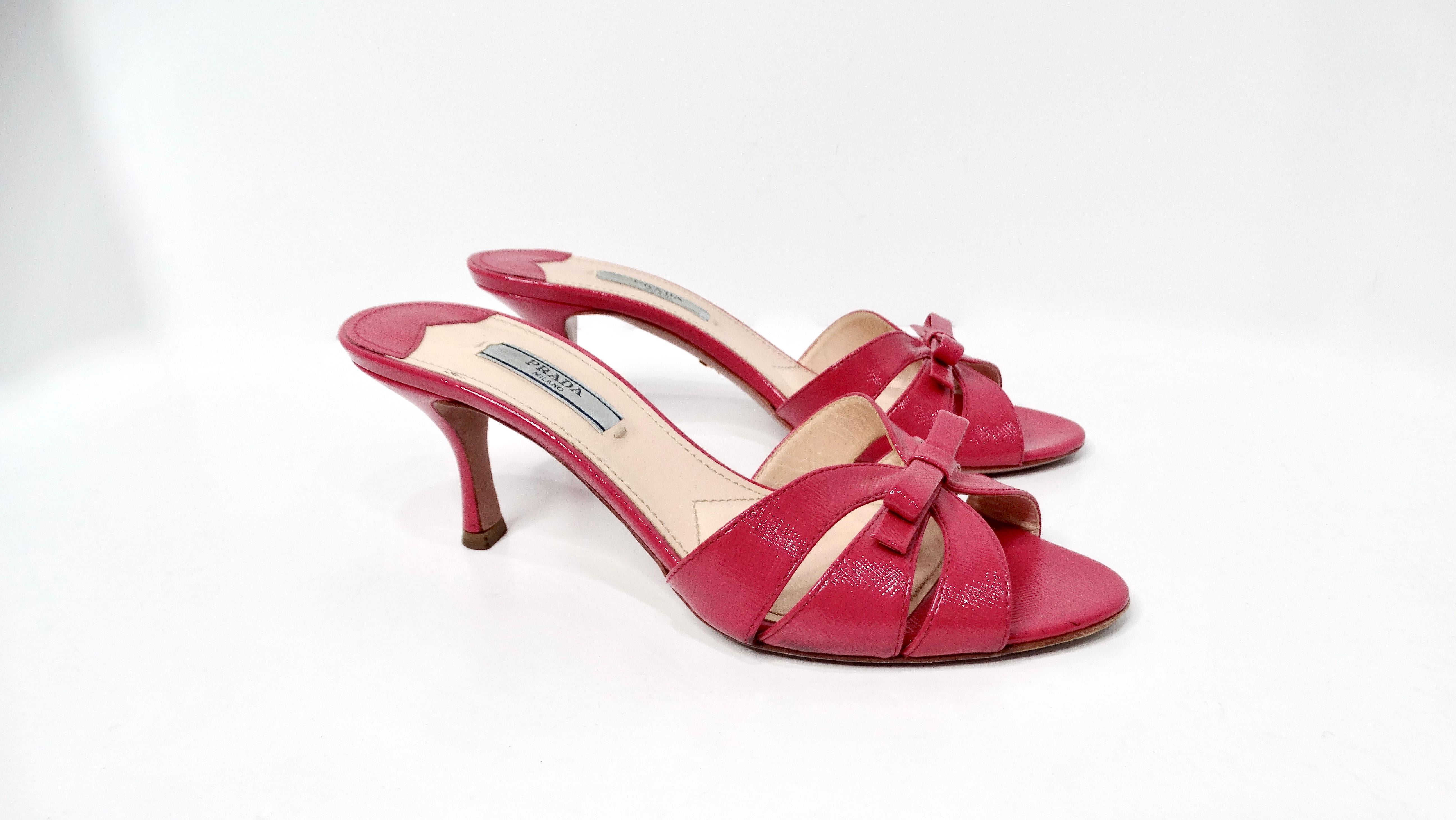 The Prada Pink Saffiano Leather Bow Slide Sandals are a perfect blend of sophistication and playful elegance. Crafted from high-quality saffiano leather, these sandals feature a vibrant pink hue that adds a pop of color to any summer or casual