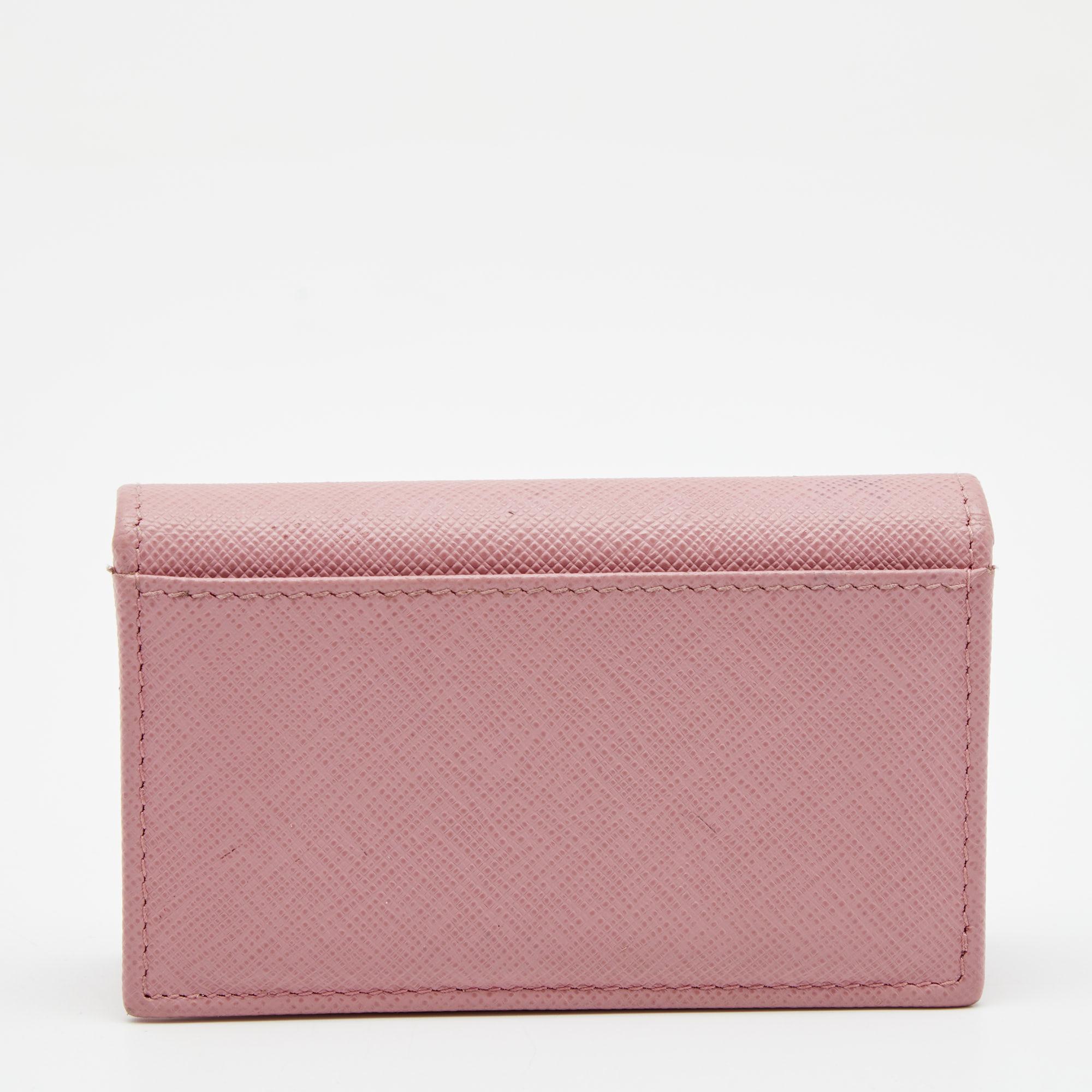 Time to organize your cards in an orderly fashion and what better way to do it than with this stylish Prada! Pink Saffiano leather cardholder has a simple design and features a leather-fabric interior. Compact and with ample space for business and
