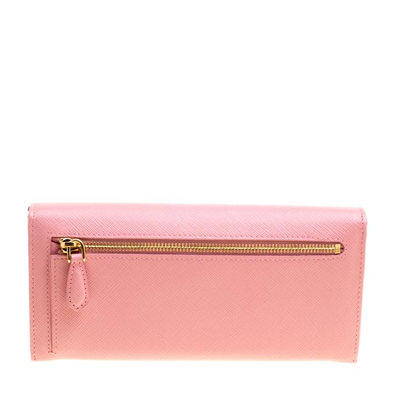 How cute does this Continental wallet from Prada look! In a lovely pink shade, this wallet is crafted from Saffiano leather and features the brand's logo at the front snap closure. With a leather and nylon interior, this wallet also profiles a back