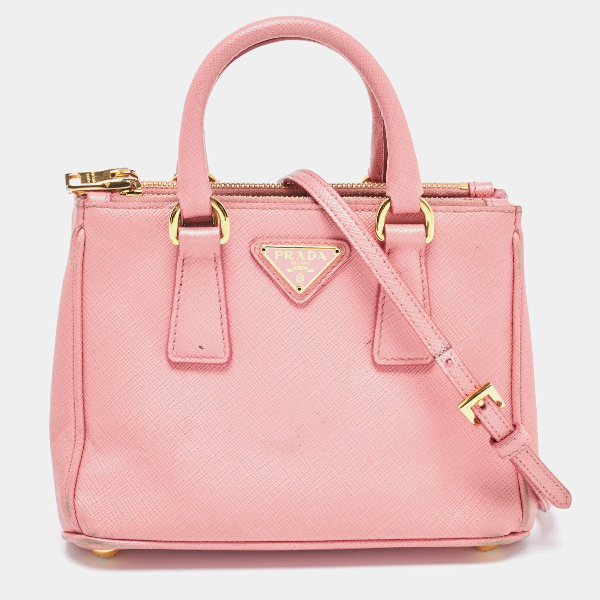 This Prada pink tote is an example of the brand's fine designs that are skillfully crafted to project a classic charm. It is a functional creation with an elevating appeal.

Includes: Detachable Strap