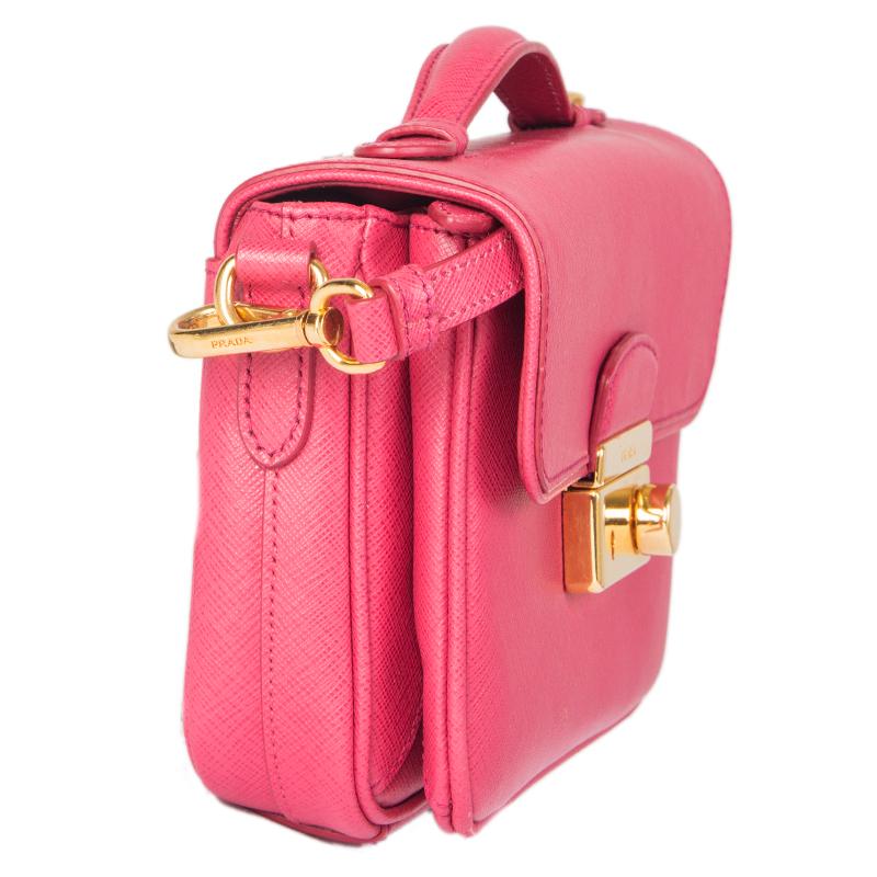Prada 'Mini Sound' crodd-body bag in pink Saffiano leather. Adjustable and detachable shoulder strap. Open pocket on the outside back. Closes with a lock on the front. Open pocket on the front under the flap. Lined in leather with an open pocket