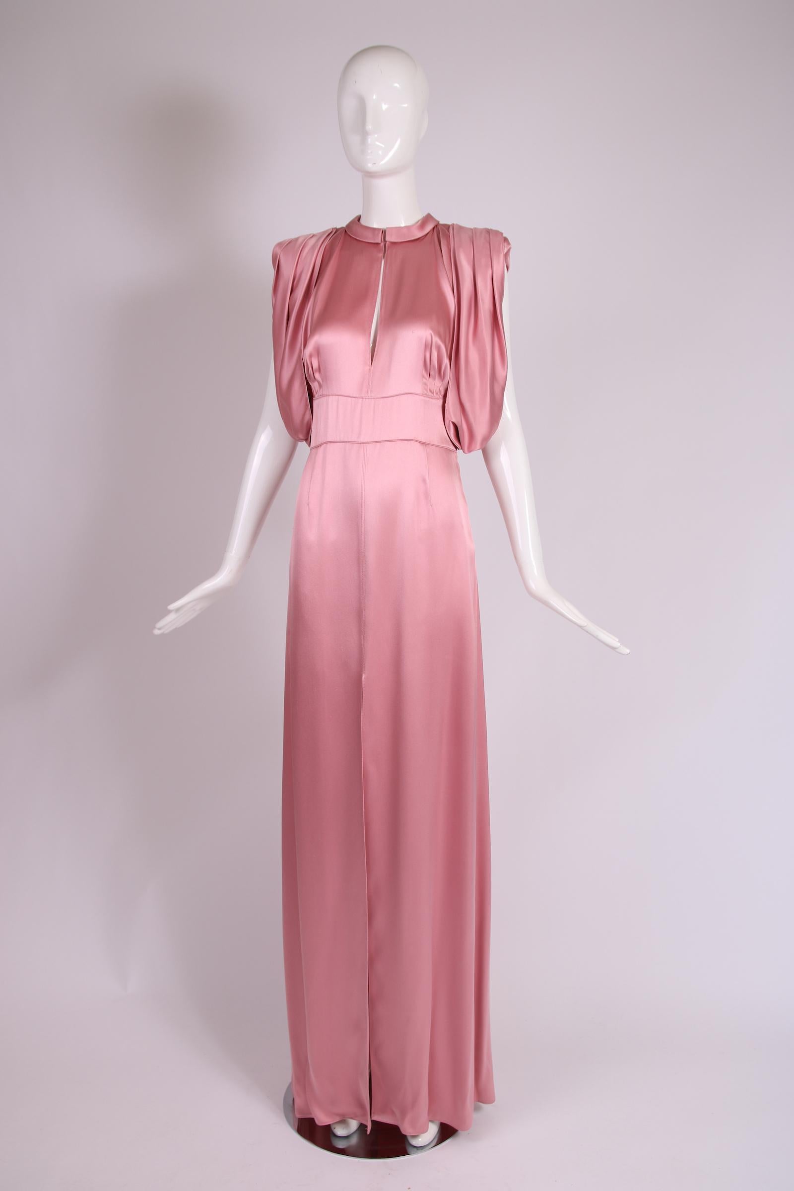 2017 Prada pink silk evening gown with a keyhole opening neckline, draped sleeves and a high frontal slit. In excellent condition with some scattered, tiny fabric abrasions. Size tag 42, fabric is a viscose/silk blend.

Bust - 34