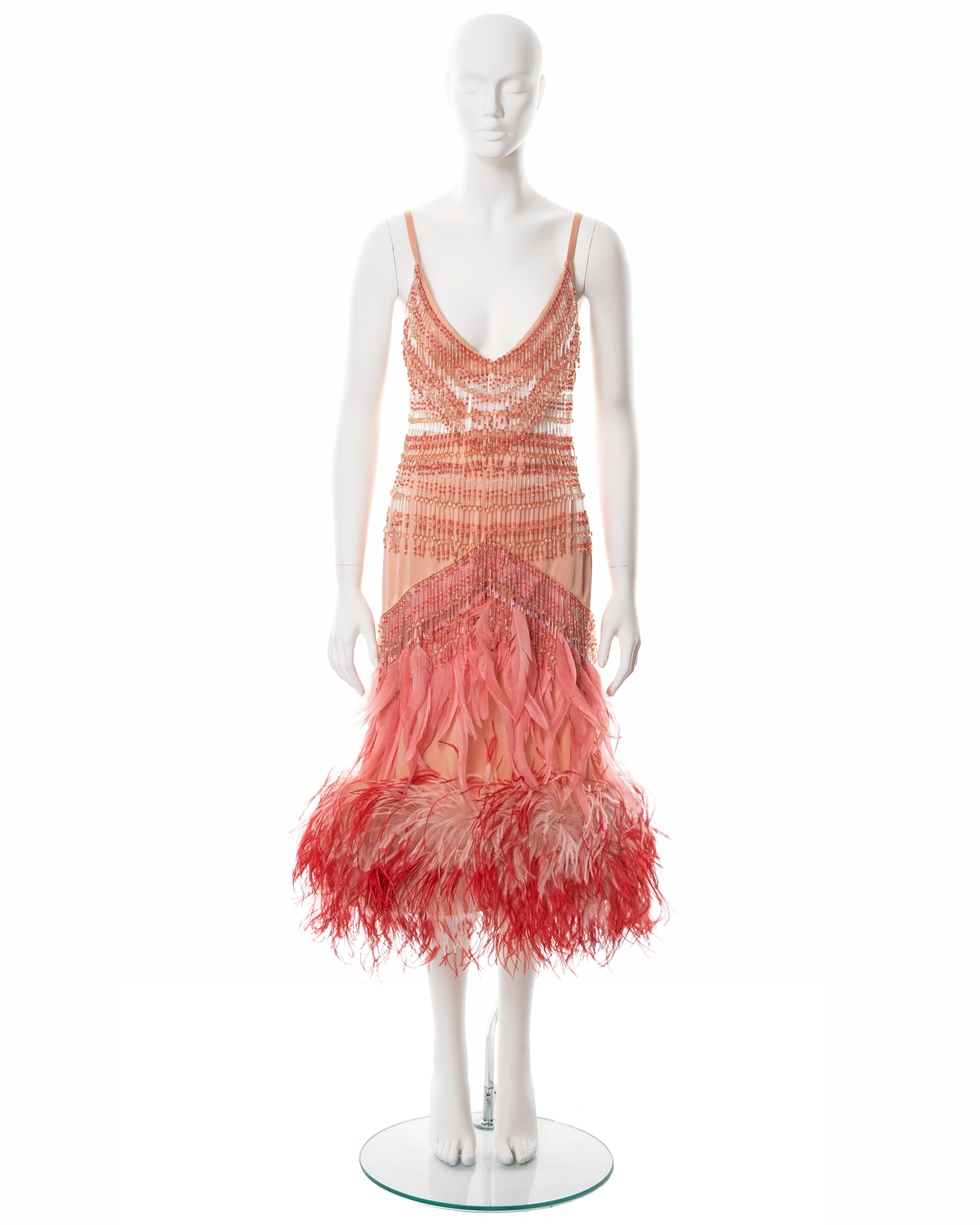 ▪ Prada evening bra and skirt ensemble 
▪ Designed by Miuccia Prada
▪ Fall-Winter 2017
▪ Constructed from salmon silk 
▪ Beaded fringe trim 
▪ Pink ostrich and turkey feather embellishments 
▪ Marked size '38', Bust: 32.5 - 34