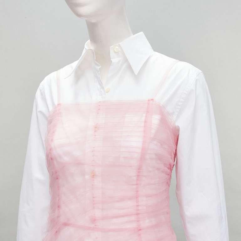 PRADA pink tulle overlay asymmetric white shirt layered top
Reference: ANWU/A00480
Brand: Prada
Designer: Miuccia Prada
Material: Feels like cotton, Tulle
Color: Pink, White
Pattern: Solid
Closure: Zip

CONDITION:
Condition: Very good, this item was