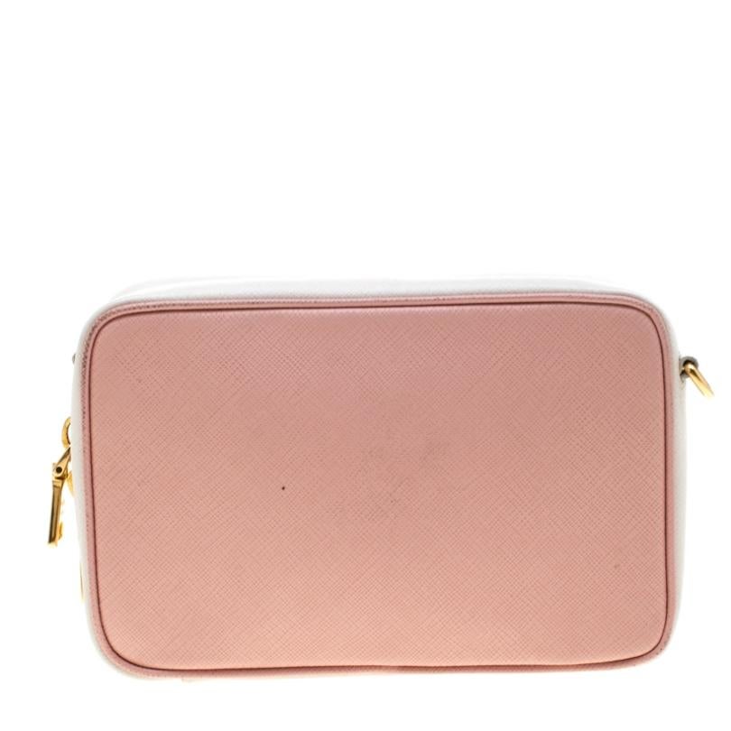 Designed to last, this beautiful bag from Prada is a prized buy. Comfortable and easy to carry, this leather creation comes in pink and white with the logo on the front. It has a shoulder strap and an interior lined with leather to keep your