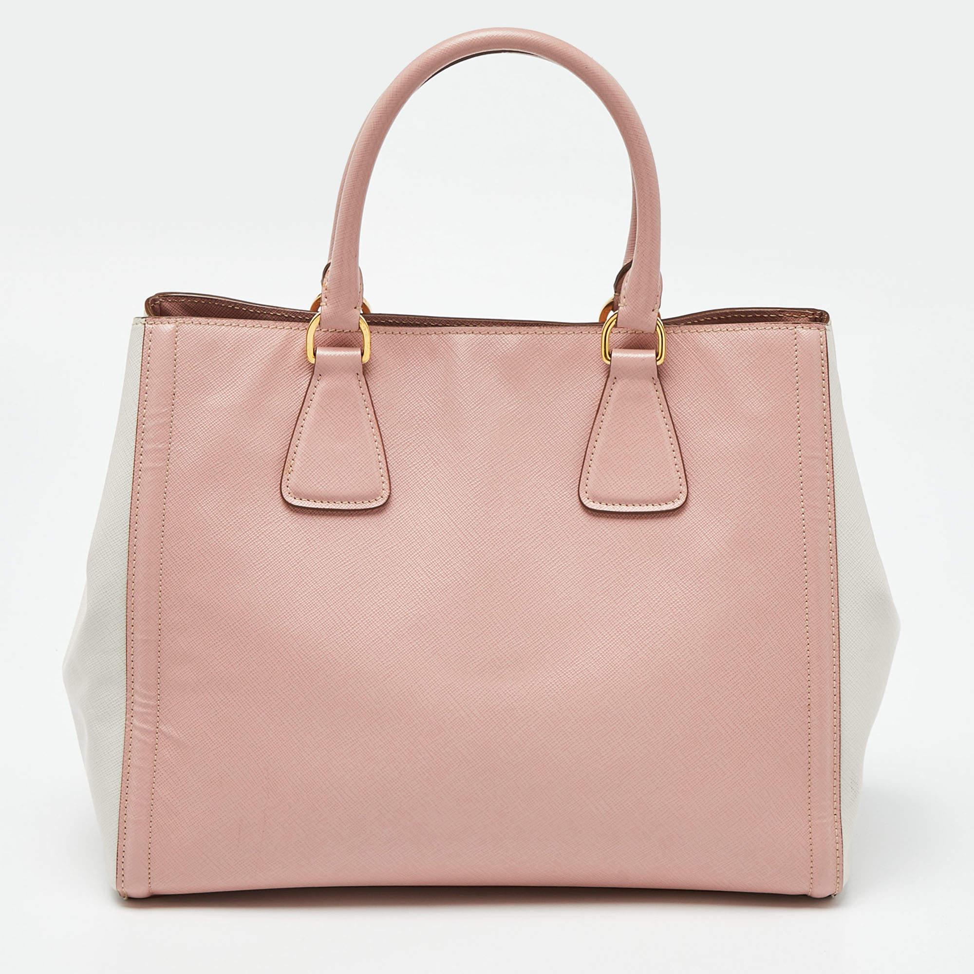 Striking a beautiful balance between essentiality and opulence, this tote from the House of Prada ensures that your handbag requirements are taken care of. It is equipped with practical features for all-day ease.

Includes: Detachable Strap,