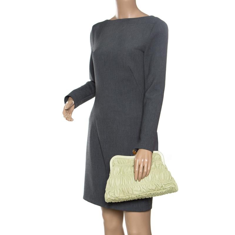 Have all eyes on you when you flaunt this stylish clutch by Prada. Crafted from subtle pistachio-coloured Nappa Gaufre leather, it has a structured frame. The Italian made beauty has a kiss-lock closure that opens to a muted leather-lined interior