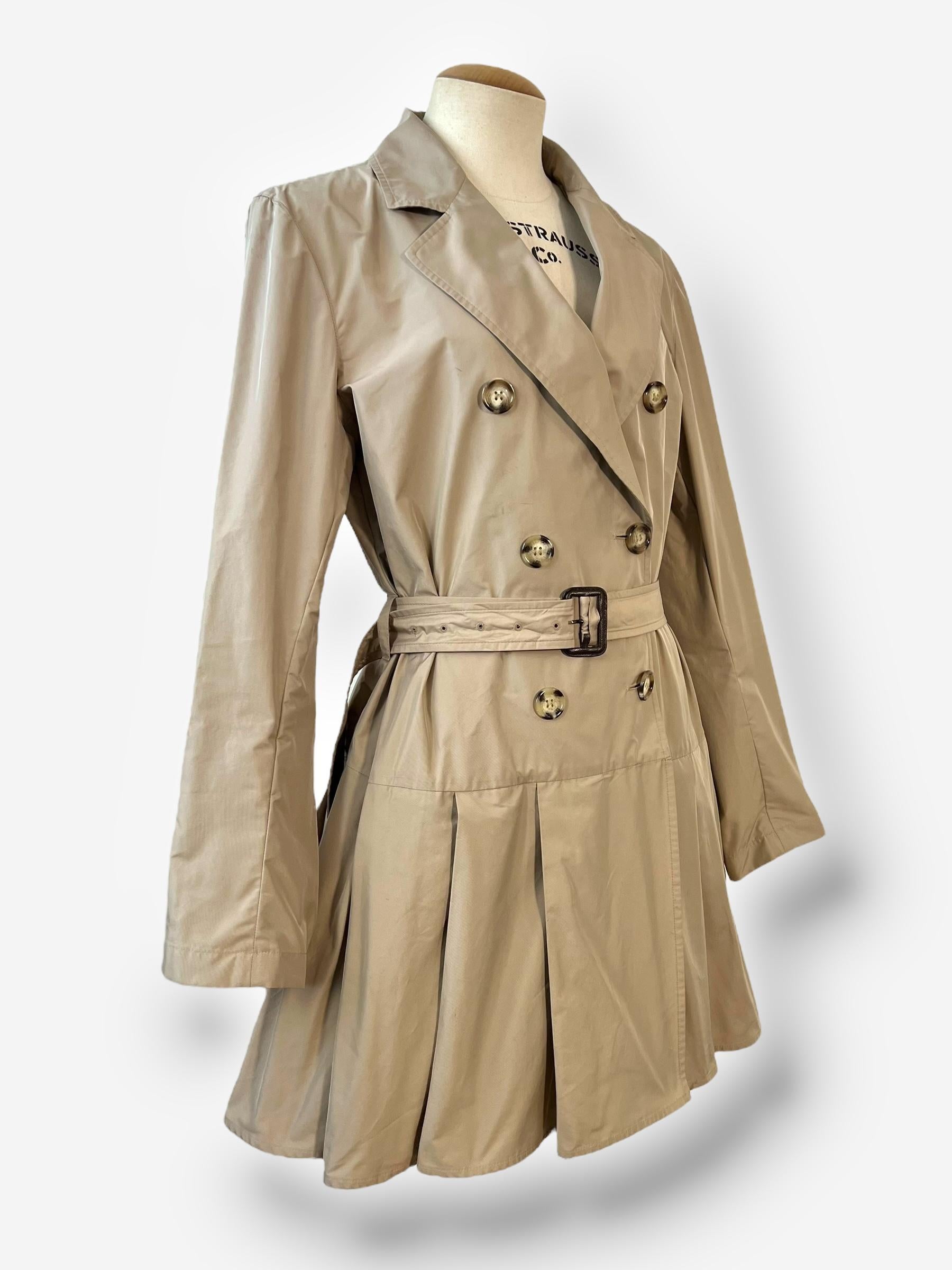 
A refined yet sporty take on the classic trench coat from Prada Sport’s 2011 collection. This piece blends utilitarian function with feminine elegance, creating a structured yet fluid silhouette.

Classic trench coat design with a modern,