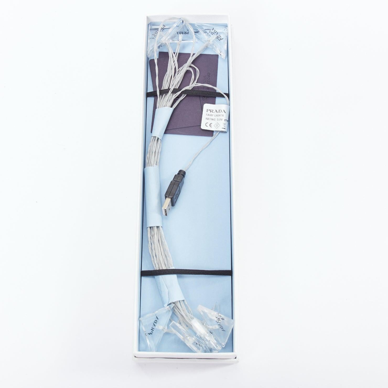 PRADA Plexiglas Fairy Lights clear acrylic black logos USB fairy LED lights
Reference: TGAS/E00480
Brand: Prada
Designer: Miuccia Prada
Model: 2QK001_2FJ4_F0009_V_OOO
Collection: 2021
Material: Acrylic
Color: Clear
Pattern: Solid
Extra Details: