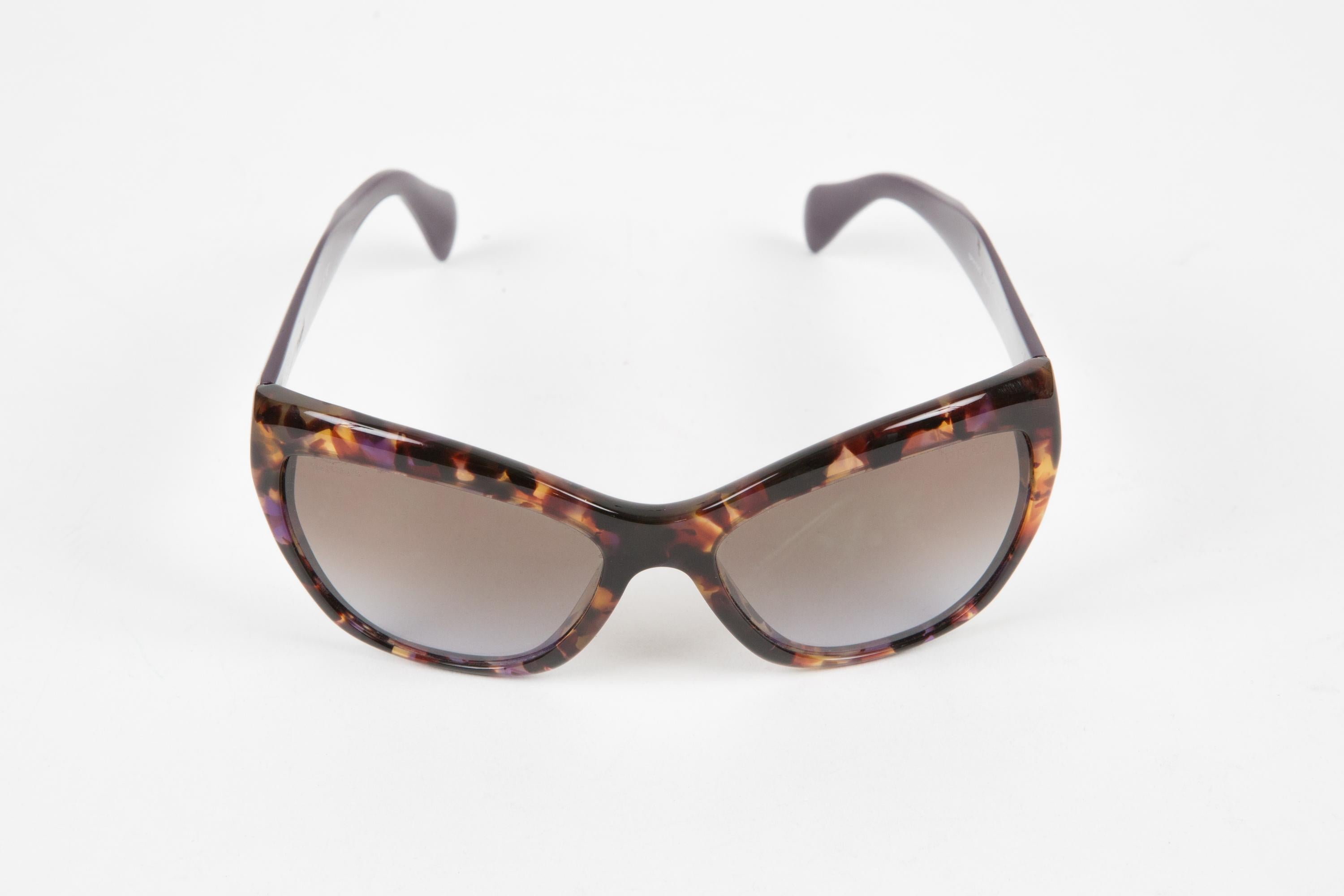 Prada Plum tortoise acetate sunglasses featuring  signature detailing at the arm, cat-eye tortoise frame, plum straight arms with curved tips. 
100% acetate. Circa 2000s.
Arm Length 5.1in. (13cm)
Lens length:2.1in. (5.6cm)
Total width: 5.4in.