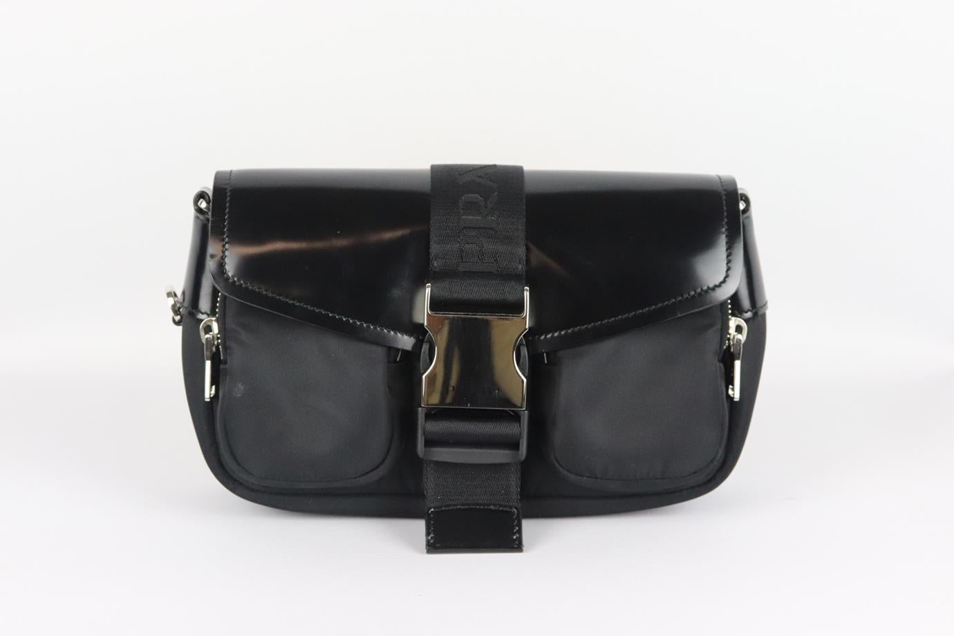 Prada Pocket leather and nylon shoulder bag. Black. Buckle fastening at front. Does not come with dustbag or box. Height: 6.4 in. Width: 2 in. Depth: 5 in. Strap Drop: 34 in. Very good condition - Barely used. Small mark at front. Light scratching