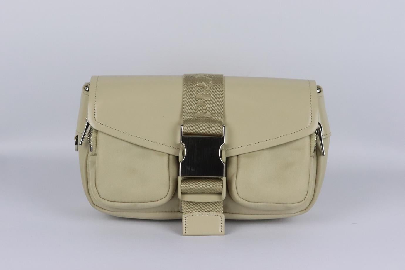Prada Pocket leather and nylon shoulder bag. Beige. Buckle fastening at front. Does not come with dustbag or box. Height: 6.4 in. Width: 2 in. Depth: 5 in. Strap Drop: 34 in. Very good condition - Barely used. Light scratching to hardware; see