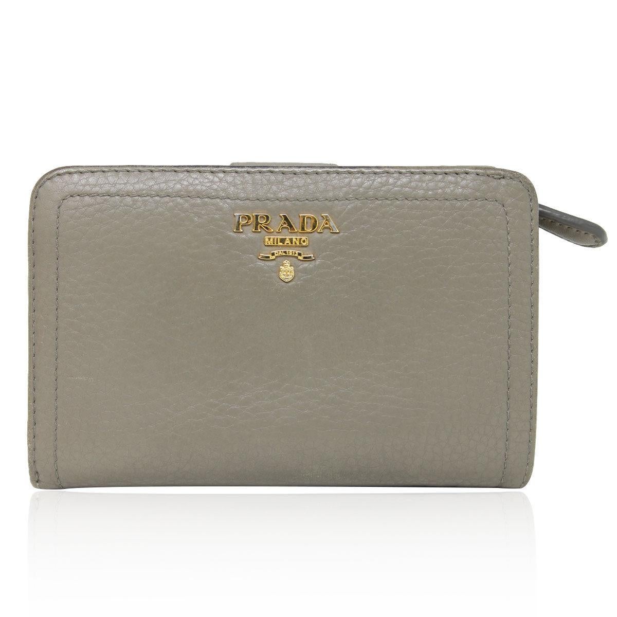 Brand: Prada
Style: Wallet
Measurements: 5.75″ x 1″ x 3.75″
Materials: Taupe/Argilla Leather
Hardware & Lining: Gold Tone Hardware, Taupe Leather Lining
Interior: 1 Zipper Coin Pouch, 10 Cards Slots, 4 Pocket compartments, 1 Banknote compartment