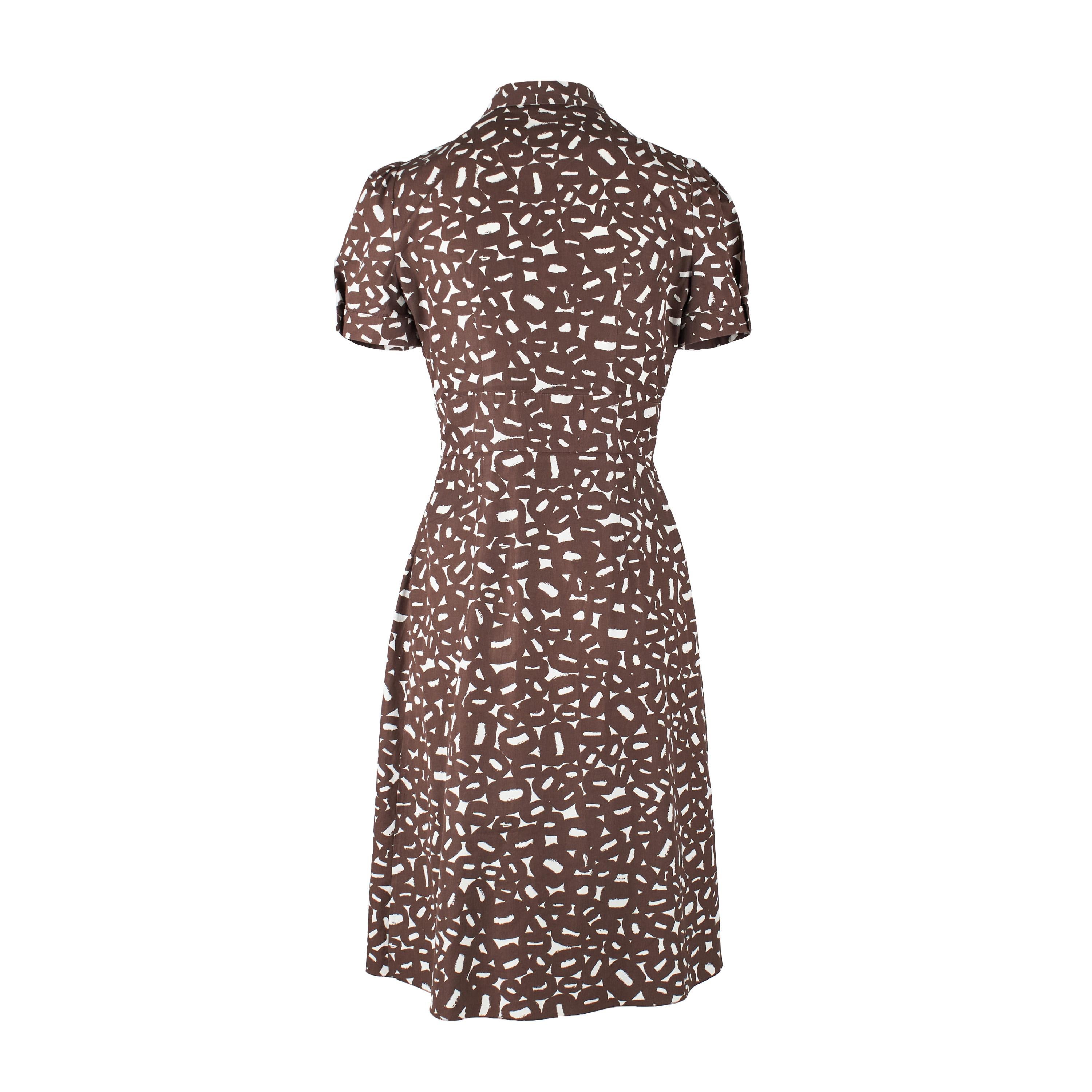 Look chic in this Prada printed midi dress, crafted from comfortable material. The serene brown abstract print is complemented by the collar, short pleated sleeves with cuffed hems, and pleats at the waist for a tailored fit. The front buttons and