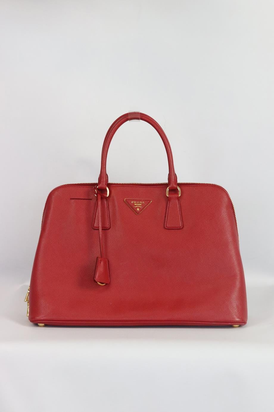 Prada Promenade Saffiano large textured leather tote bag. Made from durable red textured leather with three internal compartment and gold hardware. Black. Zip fastening at top. Does not come with dustbag or box. Height: 10.25in. Width: 14.75 in.