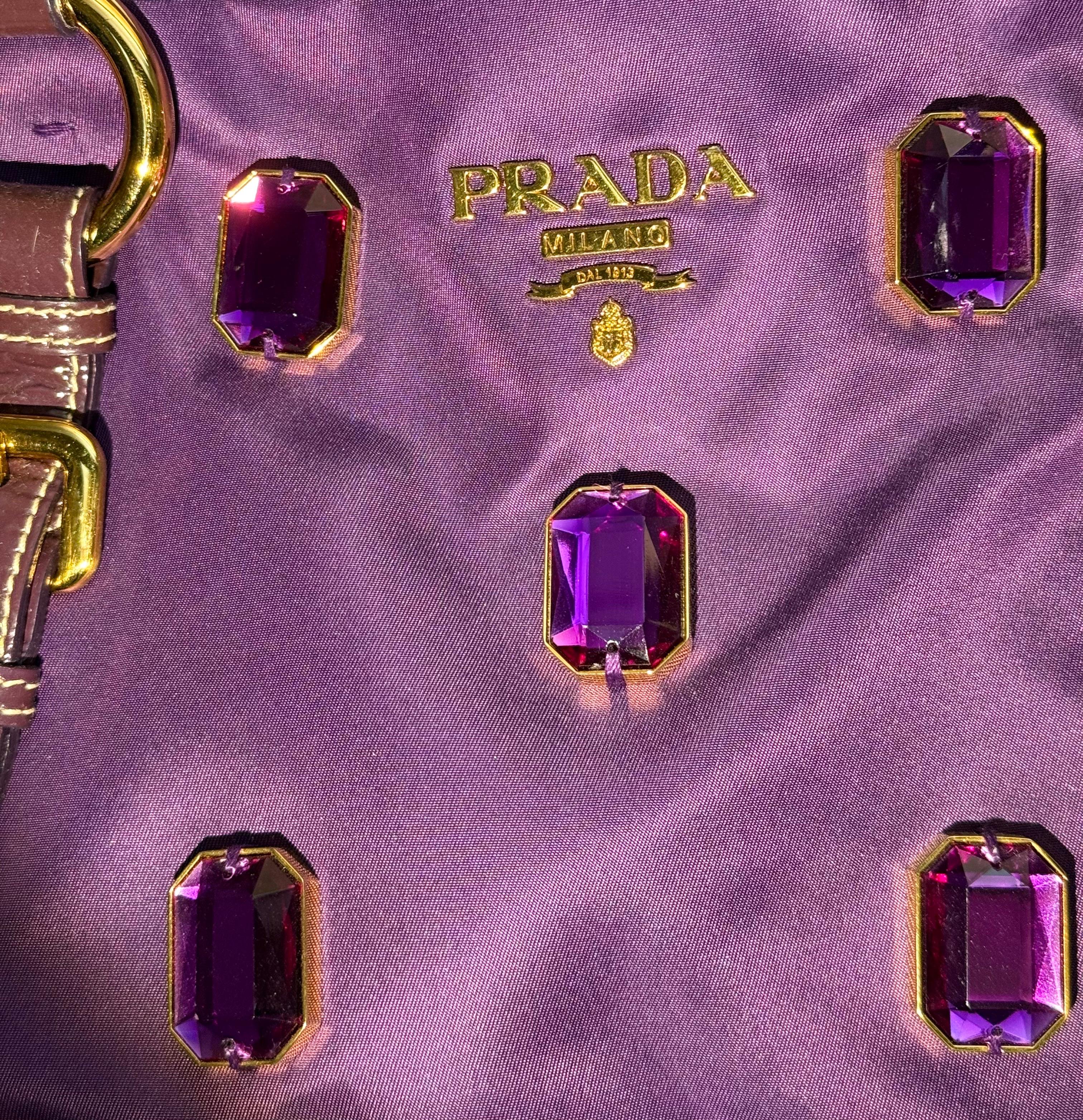 - Prada Tessuto Pietre purple nylon tote bag with purple jewels. 

- Purple patent leather straps.

- Magnetic closure.

- Prada lining.

- Interior zip pocket closure.

- 29 cm x 34 cm x 12 cm - 26 cm.

- Excellent condition.
