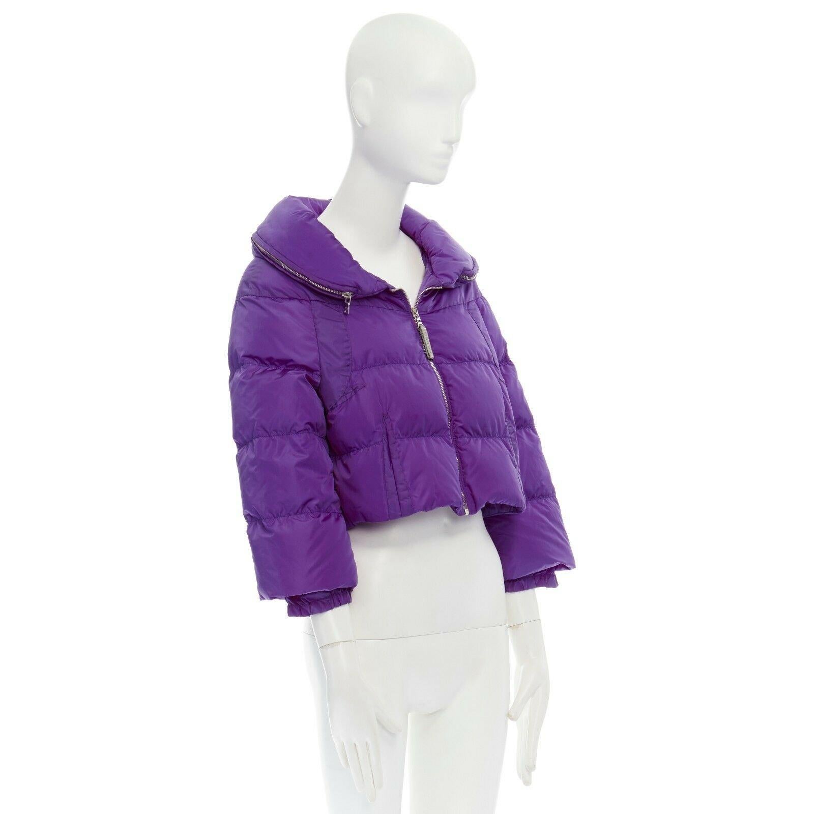PRADA purple nylon padded convertible hood 3/4 sleeves cropped down jacket IT38 Reference: CC/VAHI00207 
Brand: Prada 
Designer: Miuccia Prada 
Material: Nylon 
Color: Purple 
Pattern: Solid 
Closure: Zip 
Extra Detail: 100% nylon. 100% down padded.