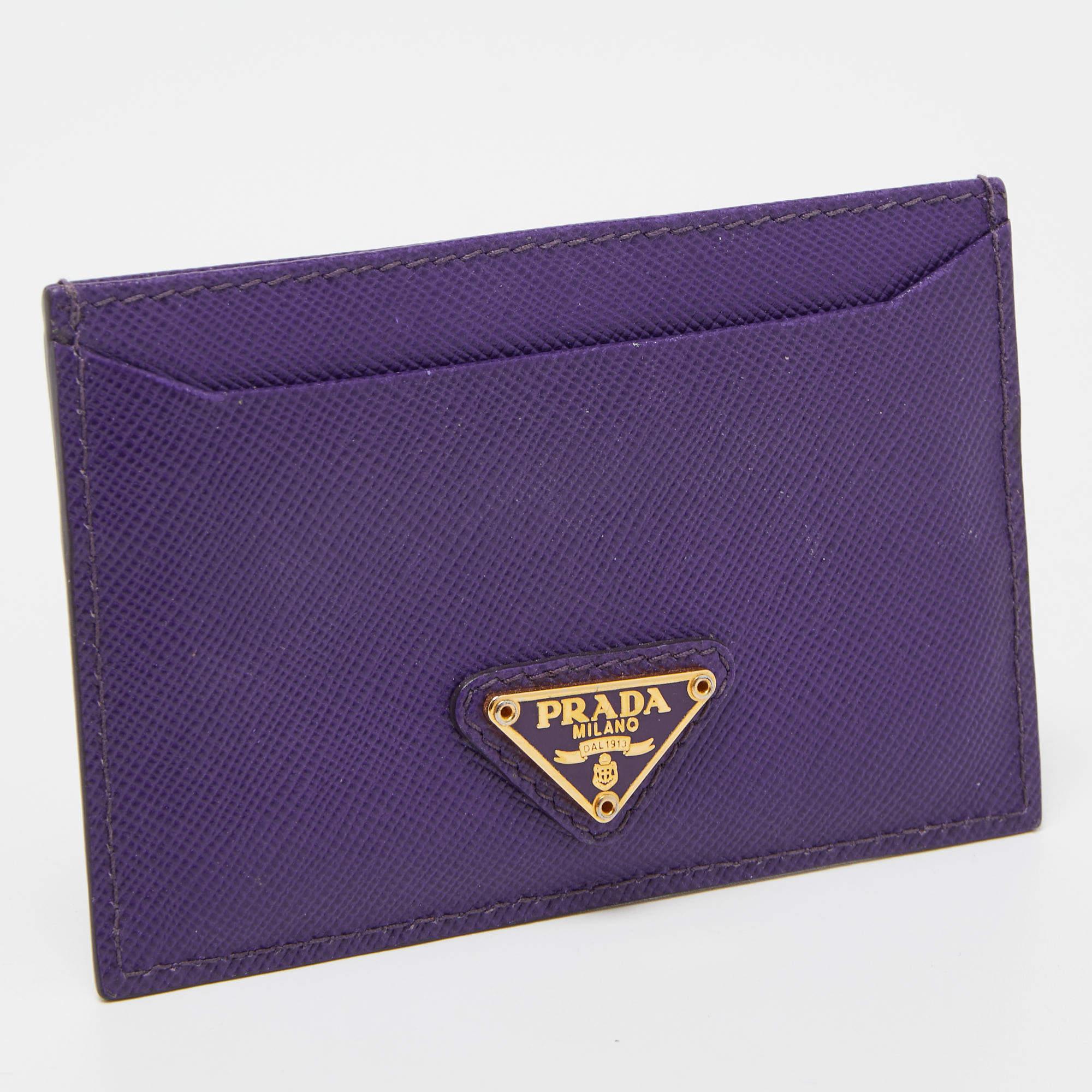 This card holder by Prada is a fine accessory to add to your everyday style edit. Crafted from Saffiano leather, it comes in a classic shade of purple and has nylon slots to hold your cards. The brand's logo makes an appearance on the front.

