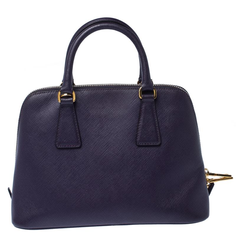 This stunning Promenade tote is high on appeal and style. Dazzling in a classy purple shade, the bag is crafted from leather and features two rolled handles. The zip closure leads way to a nylon interior with enough space for your essentials and the