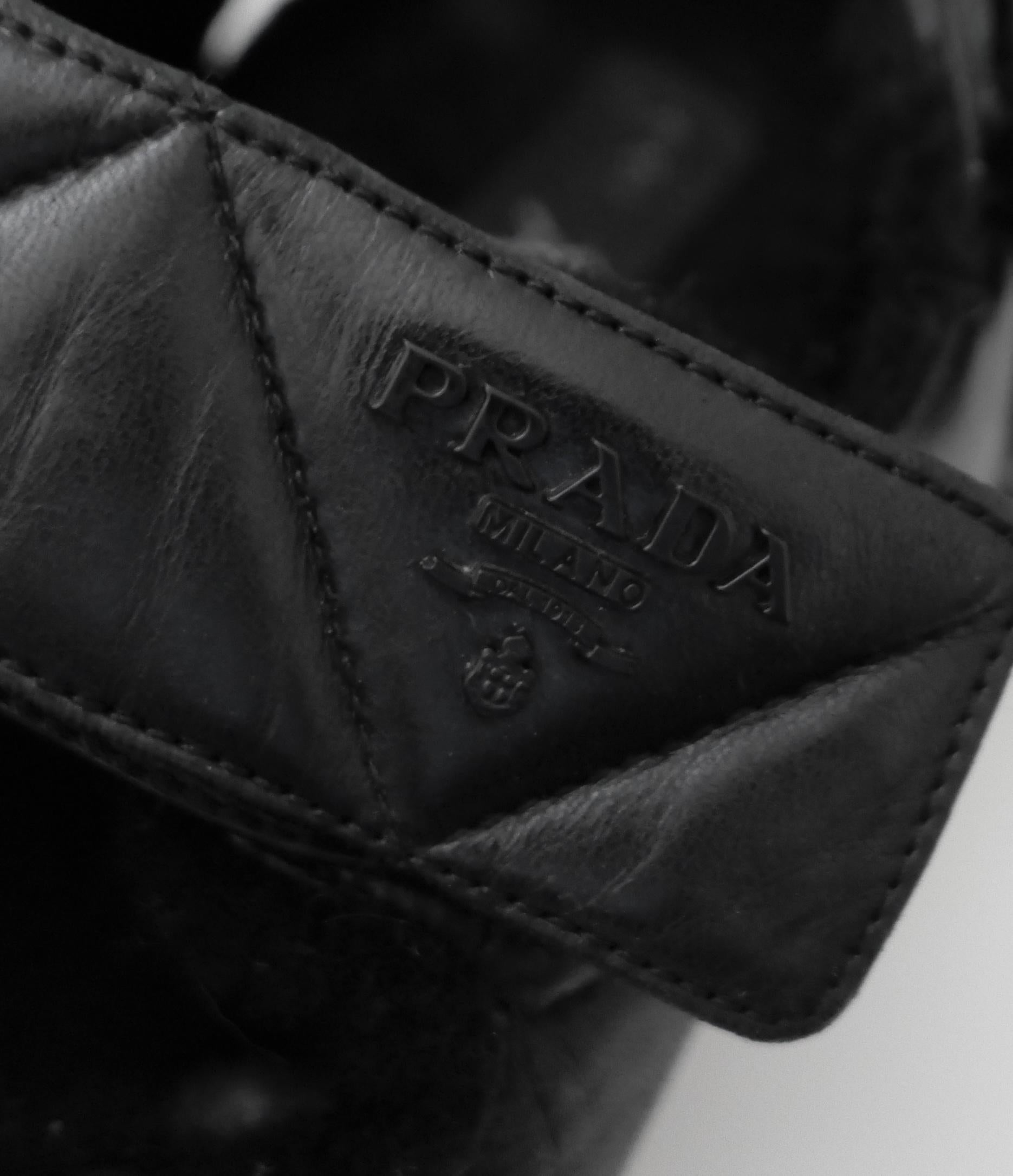 Sandali Prada freschi e comodi. Comprato per 950 sterline e indossato una manciata di volte. Viene fornito con la scatola. Realizzate in pelle liscia nera trapuntata con sottopiede foderato in shearling, placchette con logo in tono. Chiusura in