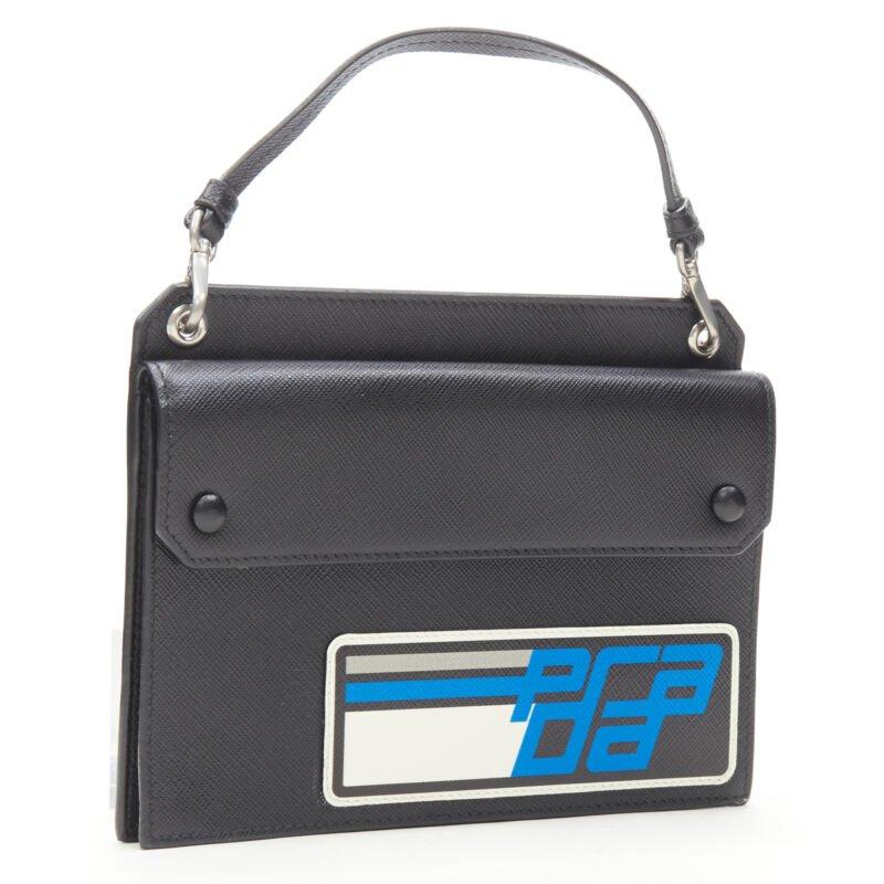Black PRADA Racing Graphic Logo black saffiano flap front pocket flat top handle bag For Sale