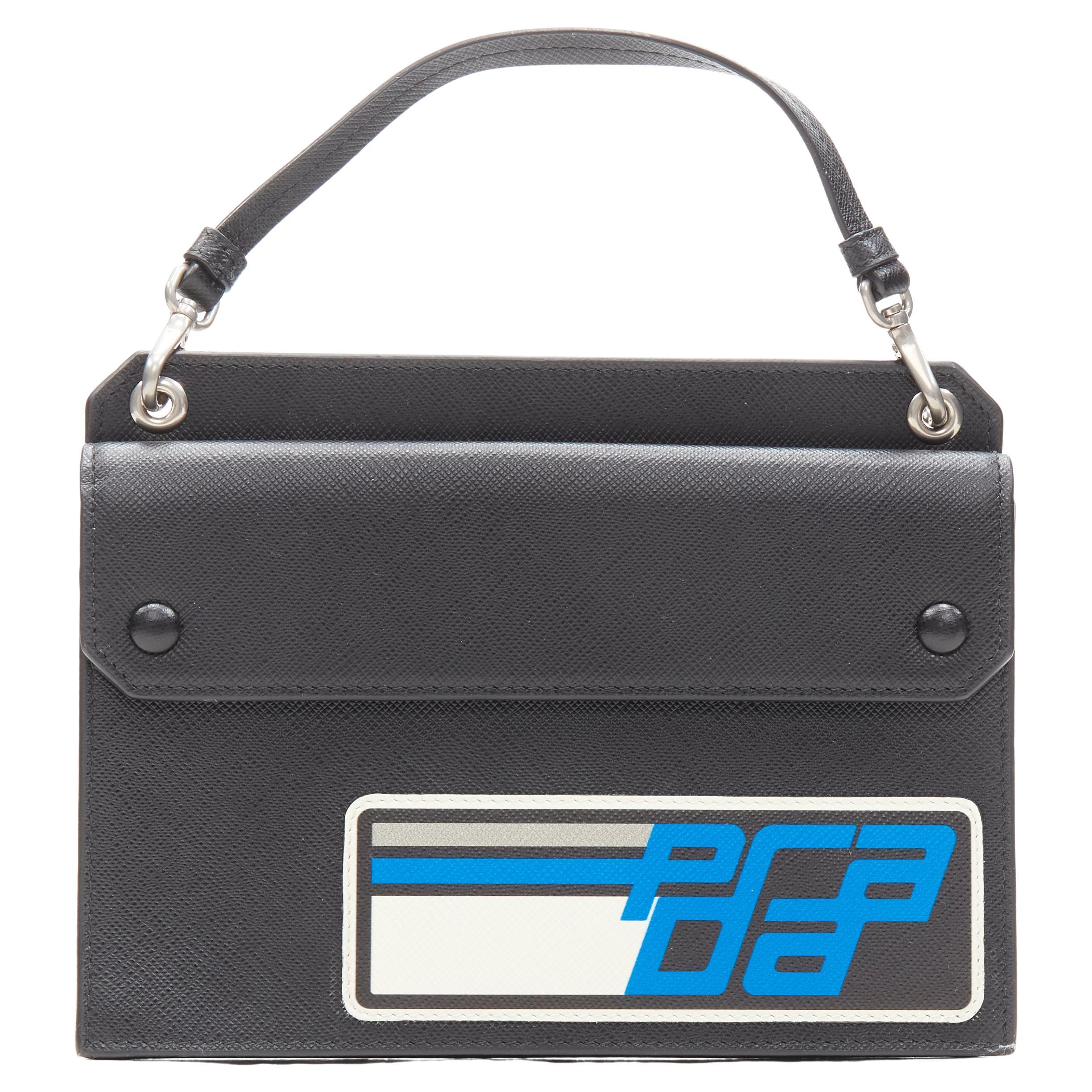 PRADA Racing Graphic Logo black saffiano flap front pocket flat top handle bag For Sale