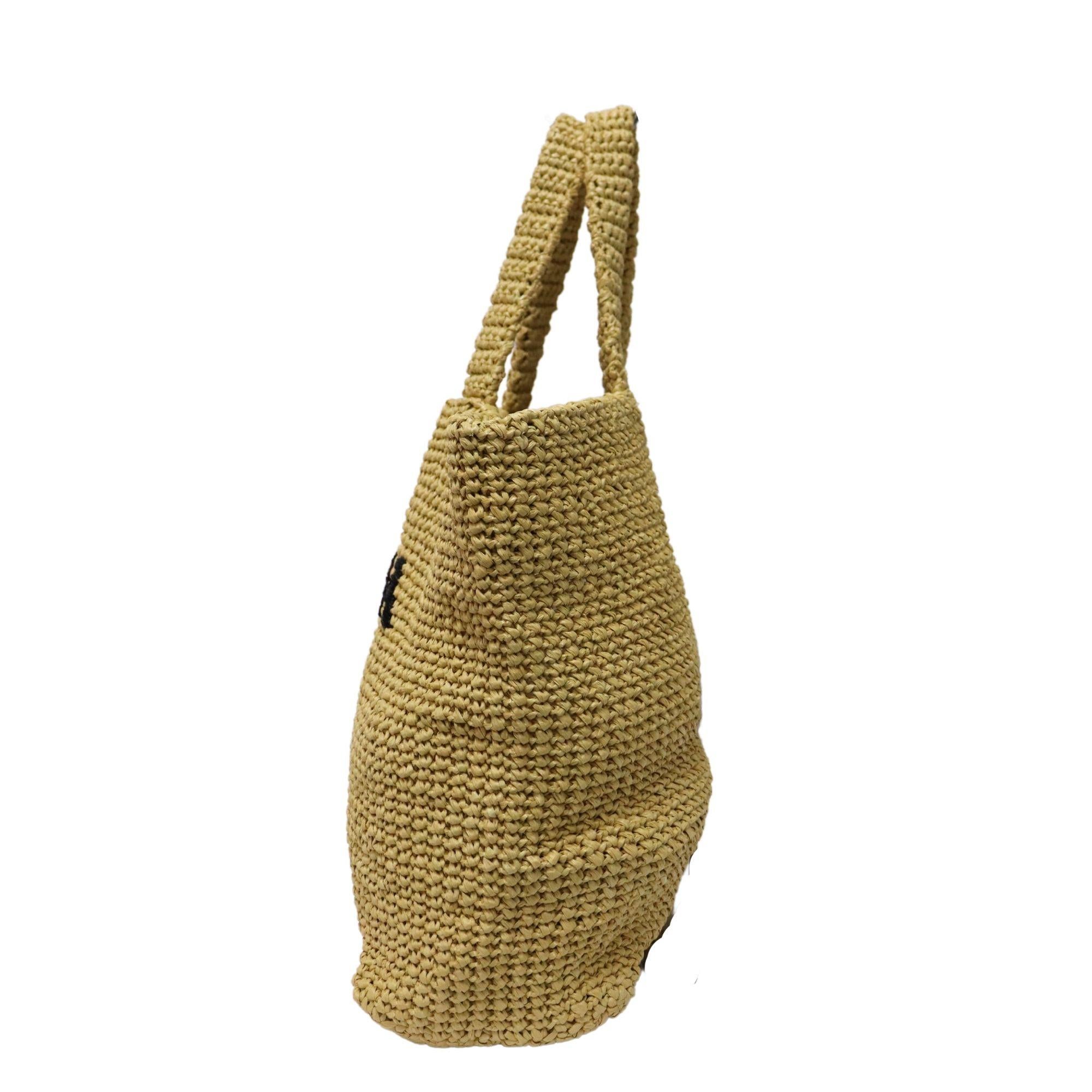 The perfect summer bag. This Prada raffia tote features light weight raffia material, embroidered iconic large front Prada lettering, and side Prada logo plague. Spacious interior.

Measurements:
Height: 34cm
Length: 16cm
Width: 40cm