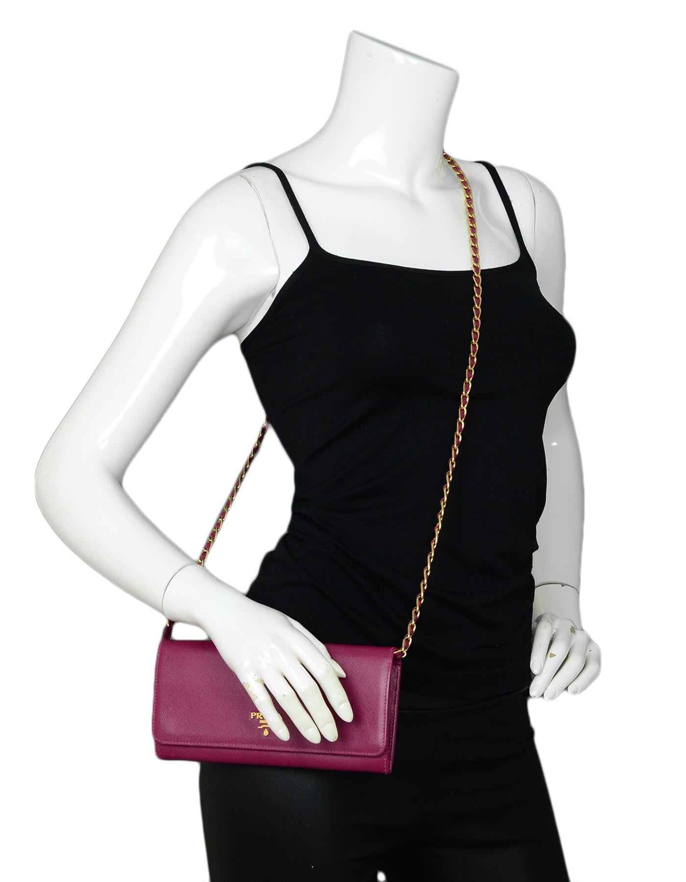 Prada Raspberry Saffiano Metal Oro Chain Wallet Crossbody Bag rt $875

Made In: Italy
Color: Raspberry
Hardware: Goldtone hardware
Materials: Saffiano leather
Lining: Raspberry leather lining
Closure/Opening: Top flap with two snaps
Exterior