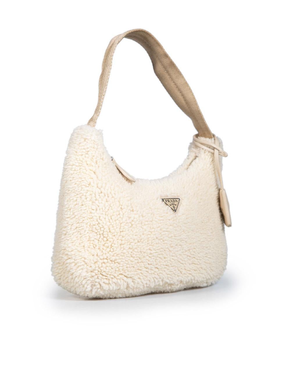 CONDITION is Very good. Hardly any visible wear to bag is evident on this used Prada designer resale item.
 
 Details
 Re-Edition 2000
 Beige
 Sheep shearling
 Mini shoulder bag
 1x Logo clochette
 1x Shoulder strap
 1x Main zipped compartment
