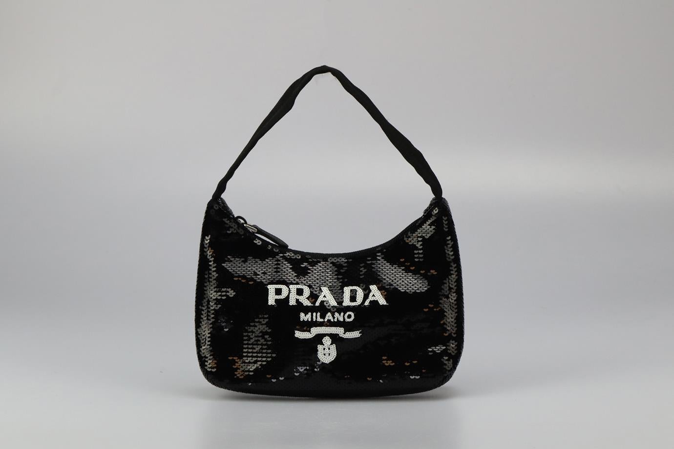 Prada Re-edition 2000 Sequined Nylon Shoulder Bag. Black. Zip fastening - Top. Comes with - authenticity card. Does not come with - dustbag or box. Height: 6.4 in. Width: 8.7 in. Depth: 2.2 in. Handle drop: 6.5 in. Condition: New without box.
