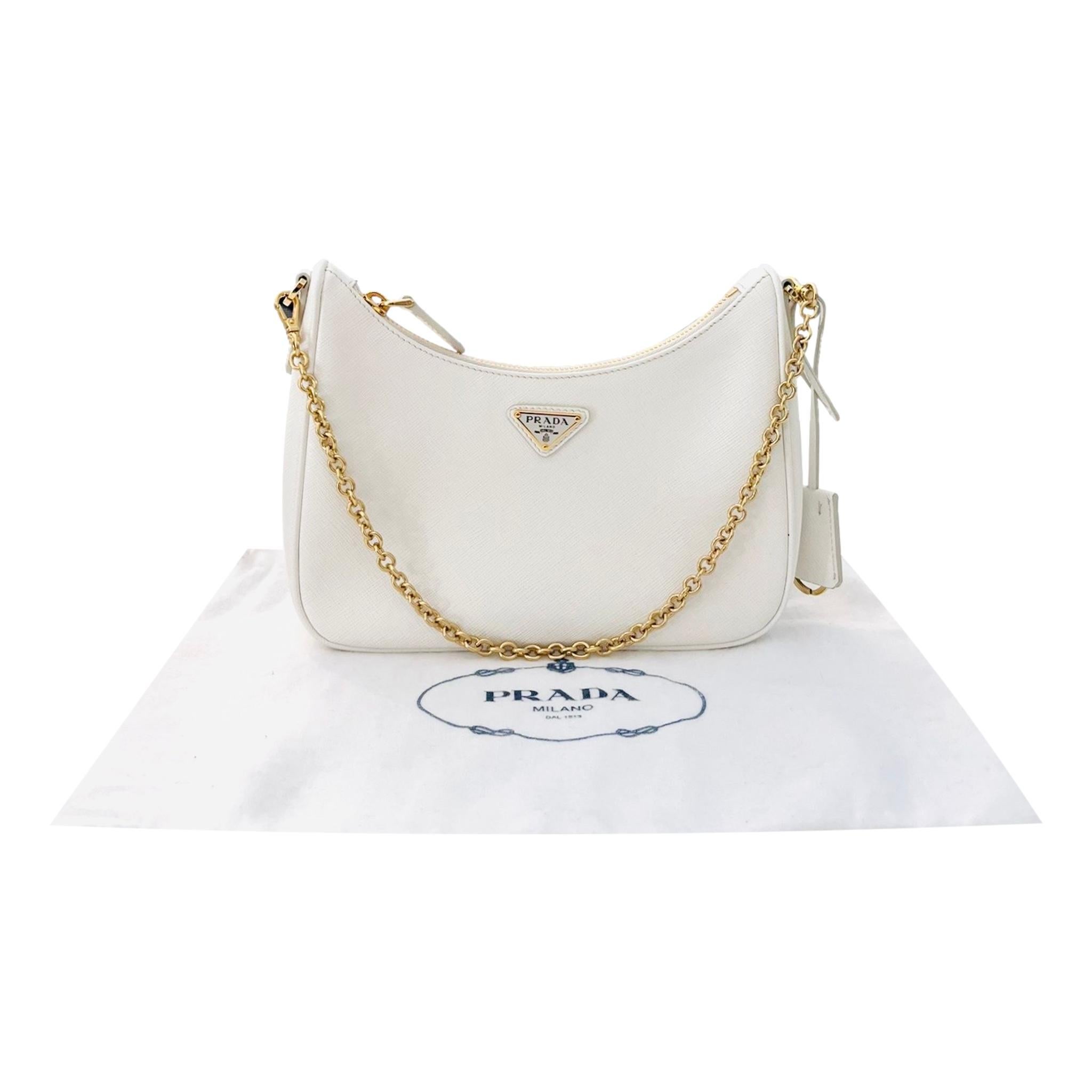 Prada Re-Edition 2005 Saffiano Leather Shoulder Bag

White bag crafted in Saffiano Leather with signature 'Prada' triangle logo to the centre.

Detailed with gold hardware and branded, removable pouch and keychain.

Featuring detachable golden chain