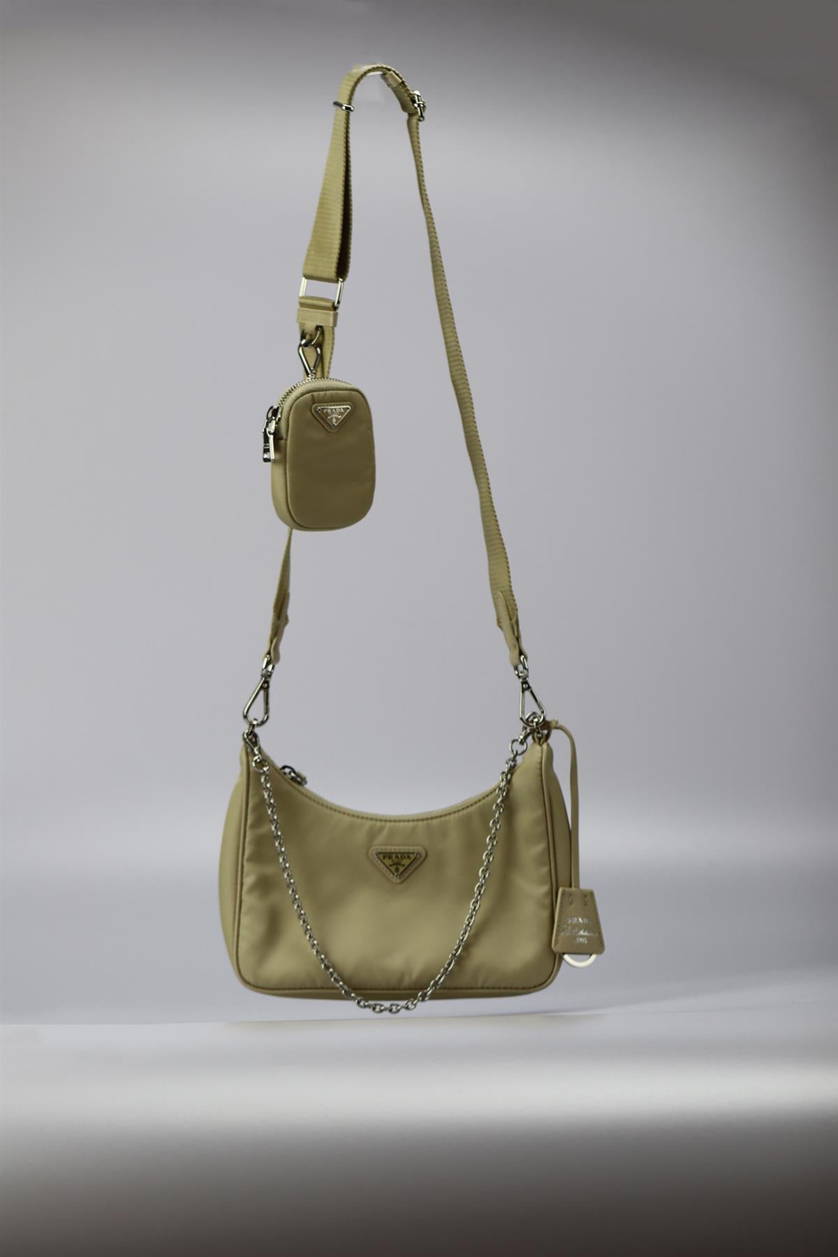 Prada Re-edition 2005 Textured Leather And Nylon Shoulder Bag. Beige. Zip fastening - Top. Does not come with - dustbag or box. Height: 6.4 In. Width: 8.5 In. Depth: 2.2 In. Handle drop: 10.5 in. Strap drop: 19.7 In. Condition: Used. Very good