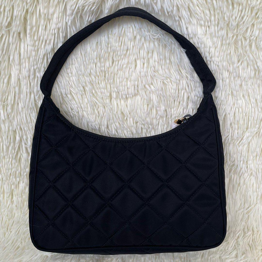 This Prada mini hobo bag is made quilted lightweight nylon and features zipper closure, 
woven tape handle and is adorned with the iconic enameled metal triangle logo.

Designer: Prada
Model: 1NE051
Style: Hobo / Shoulder Bag
Measurements: 9