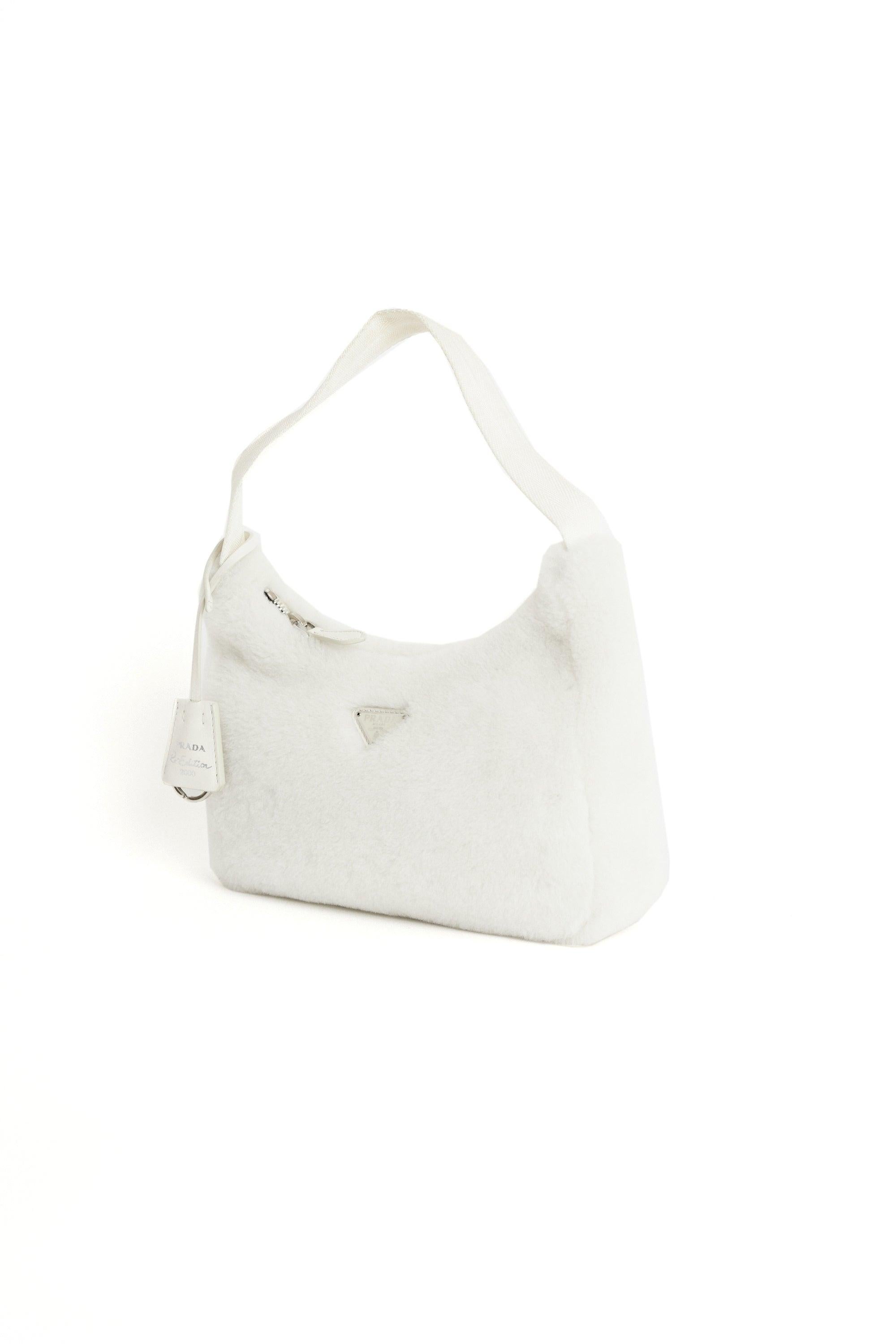 Prada re-edition white shearling hobo bag. Features a keychain and zip closure. Pre-loved, in excellent vintage condition.
Brand: Prada
Color: White
Hobo bag
Fabric: Shearling, Leather
Dustbag: Yes
Authentication card: No
Serial number: