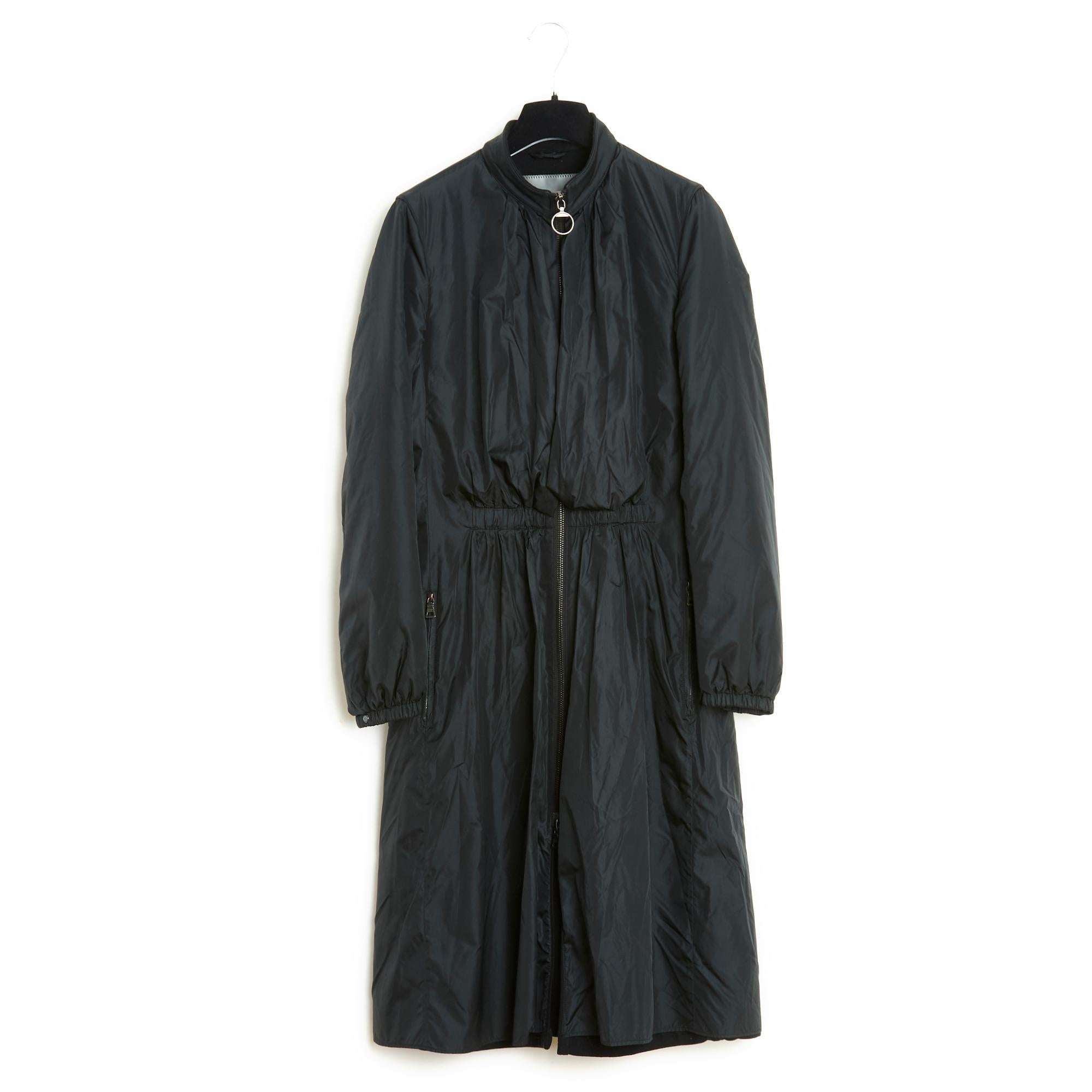 Prada Re-Nylon series coat in black polyester technical canvas, stand-up collar embellished with a black removable fur collar with buttoned closing tab, technical canvas lined and draped over the bust, long double-slider zip at the front, elastic