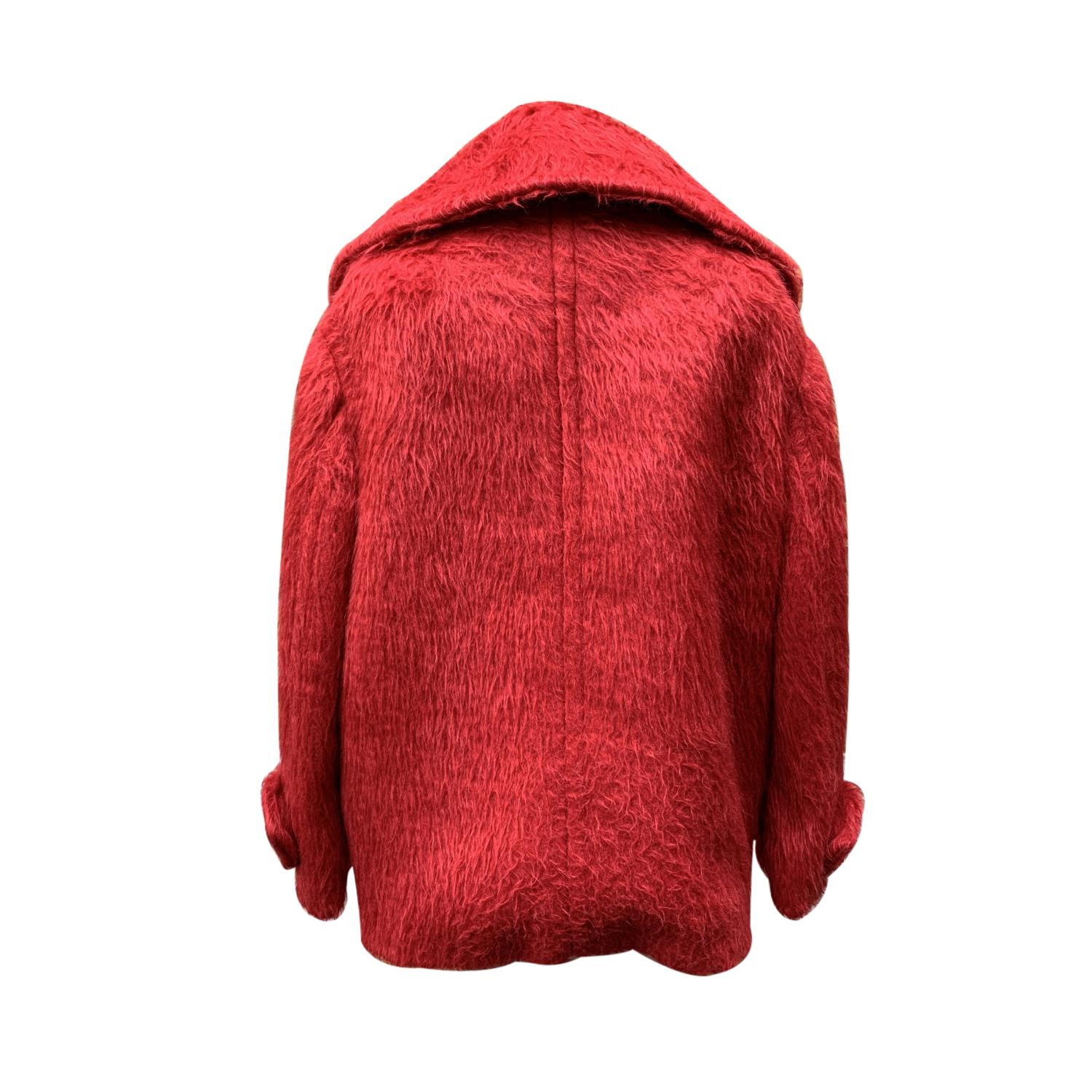 Prada red 'Fur Alpaca' women caban jacket. Long sleeve styling. Wide lapel collar. Front button closure. Extra button included. 2 pockets on the hips with flaps. Composition: 70% Alpaca, 30% Virgin wool. Lined. Made in Italy. Size 38 IT (it should