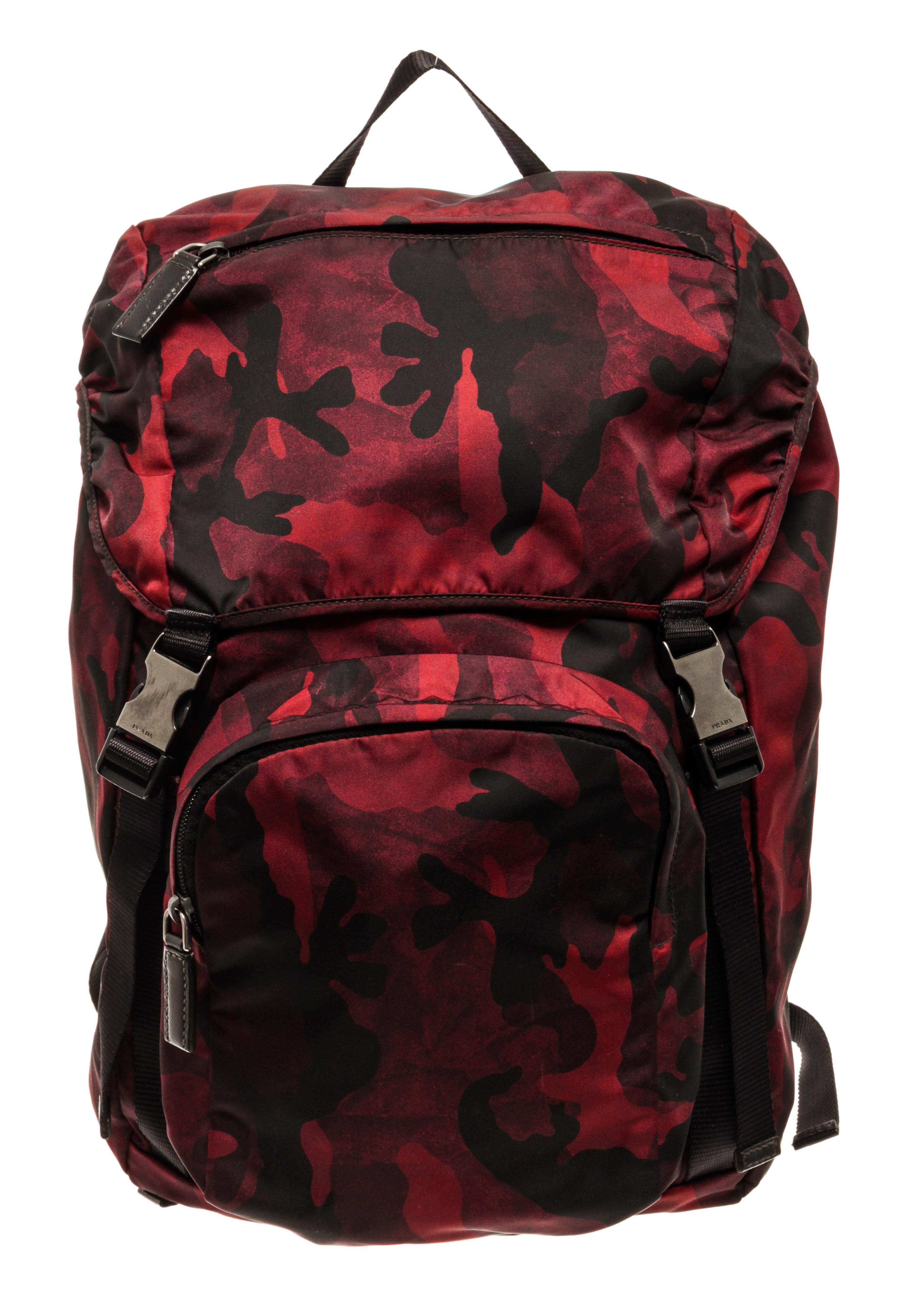 Prada red camouflage tessuto backpack with adjustable straps, one exterior zipper pocket on the top flap, one exterior zipper pocket on the front, double buckle, and drawstring and flap closure.

83192MSC