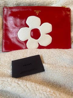 Prada red clutch with flower.