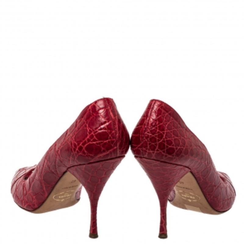 You are sure to love these amazing pumps from Prada as they're well-built and utterly gorgeous! They've been crafted from embossed leather in a red hue and designed with peep toes, 10 cm heels, and comfortable insoles.