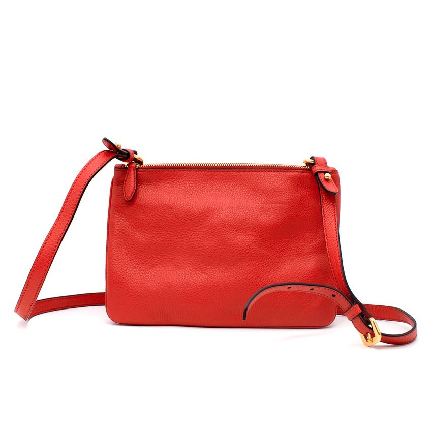 Prada Red Leather Bandoliera Cross Body Bag

- Practical bag with two different compartments
- Zip closure with gold-tone metal hardware throughout
- Red satin branded interior lining 
- Black leather edge finishes
- Adjustable and detachable