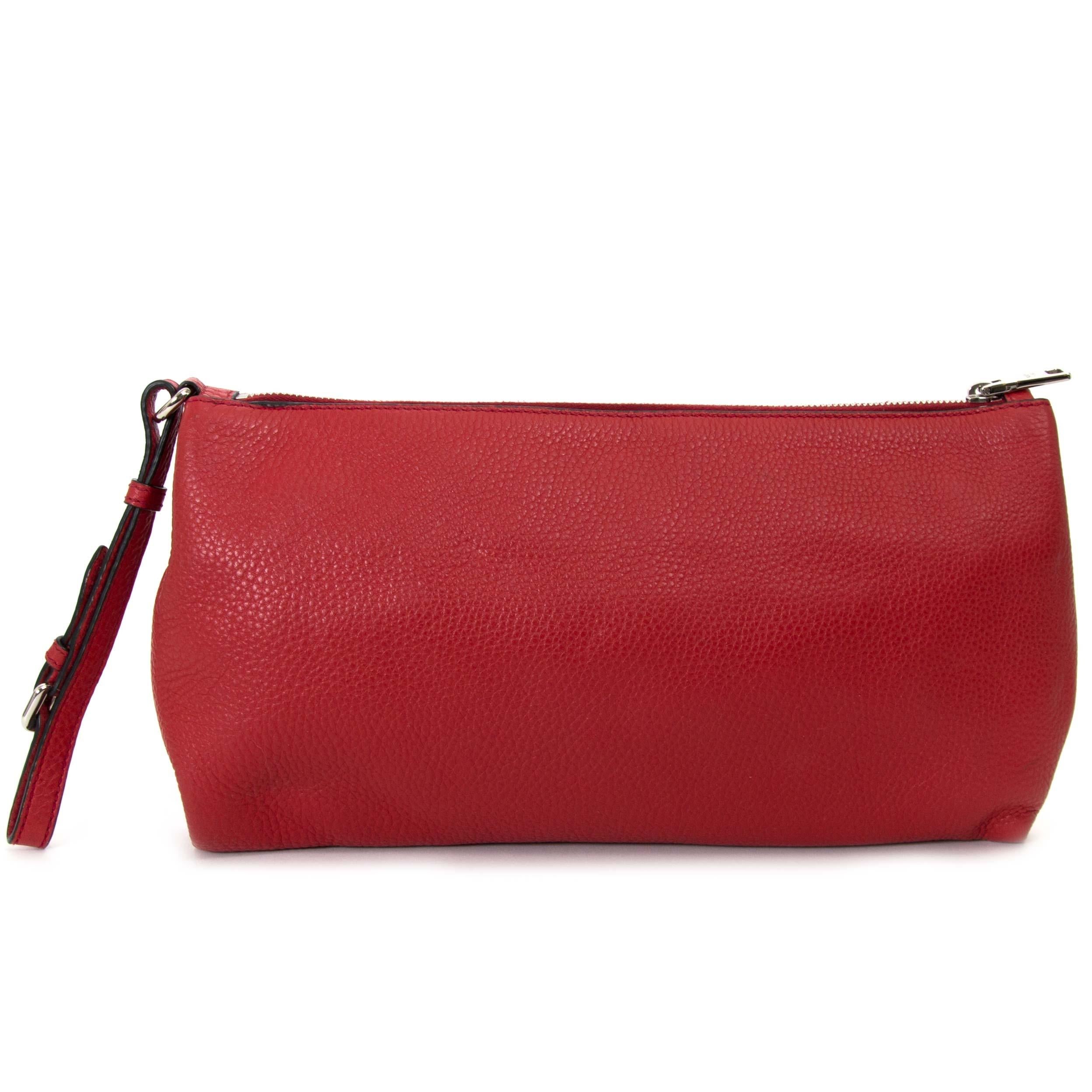 BRAND NEW!

Prada Red Leather Clutch

This beautiful Prada clutch is crafted in red leather and features silver-toned details. 
The clutch opens with a silver-toned zipper and has the iconic Prada logo in the front.
The bag has a red leather wrist